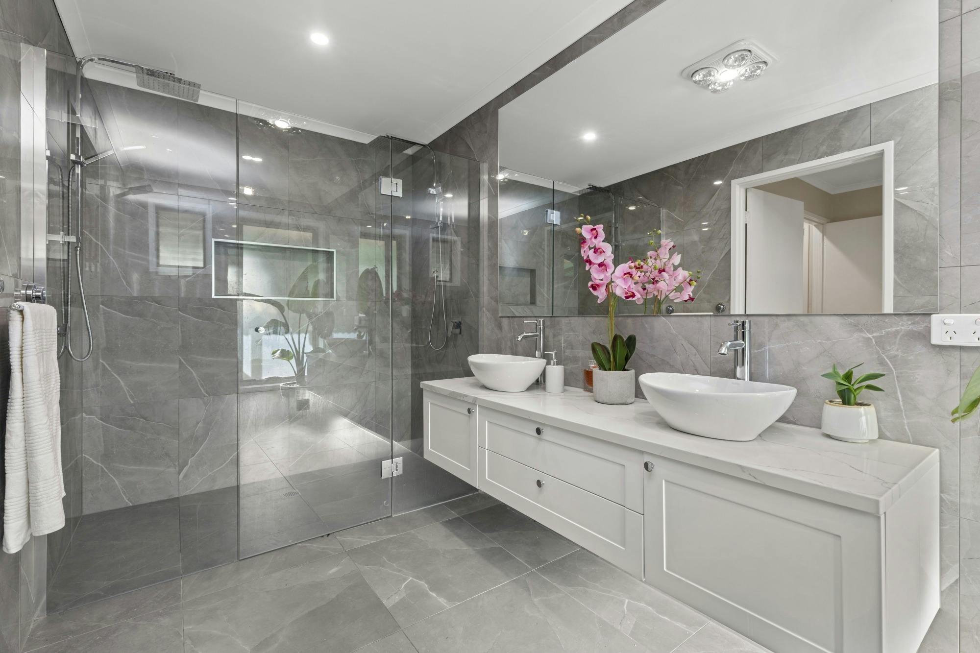 Private ensuite to the master bedroom featuring a walk-in shower, vanity, and sleek finishes