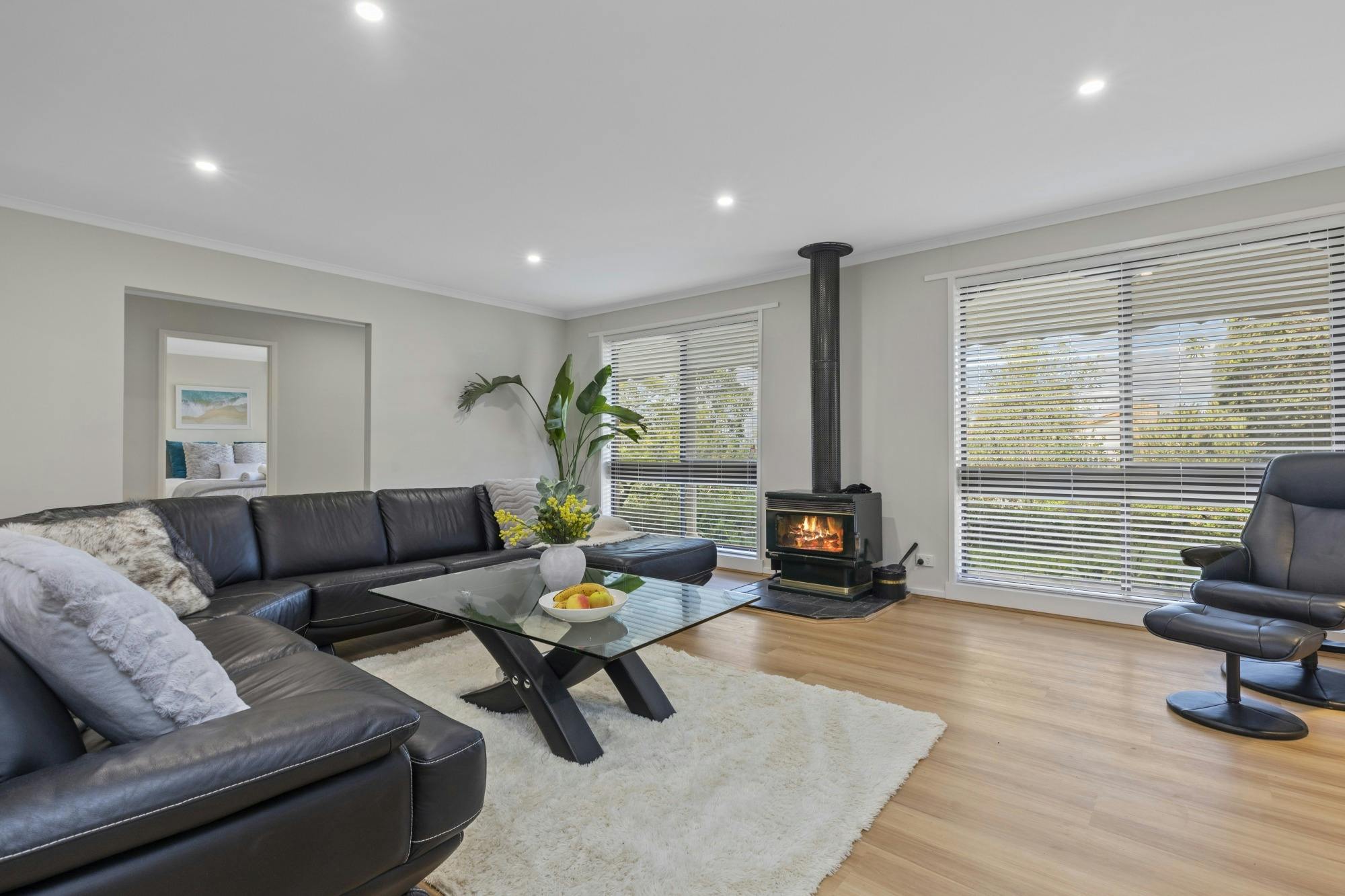 Light-filled living room with stylish furnishings, smart TV, and reverse-cycle air conditioning — de