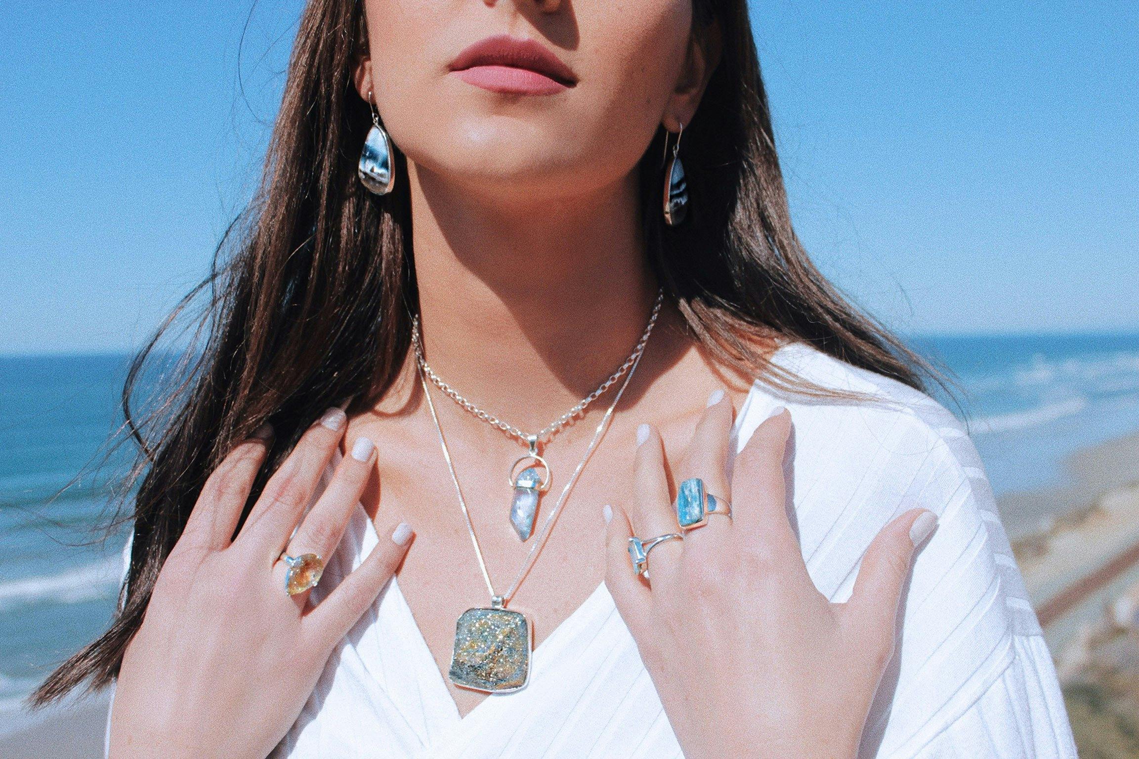 Raw and polished gemstones set in sterling silver jewellery. Aquamarine, rainbow pyrite, blue opal.