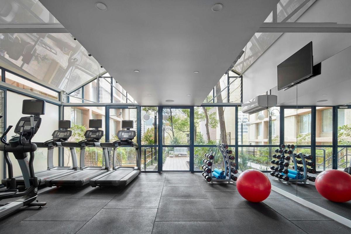 Fully equipped gymnasium with natural light and free weights
