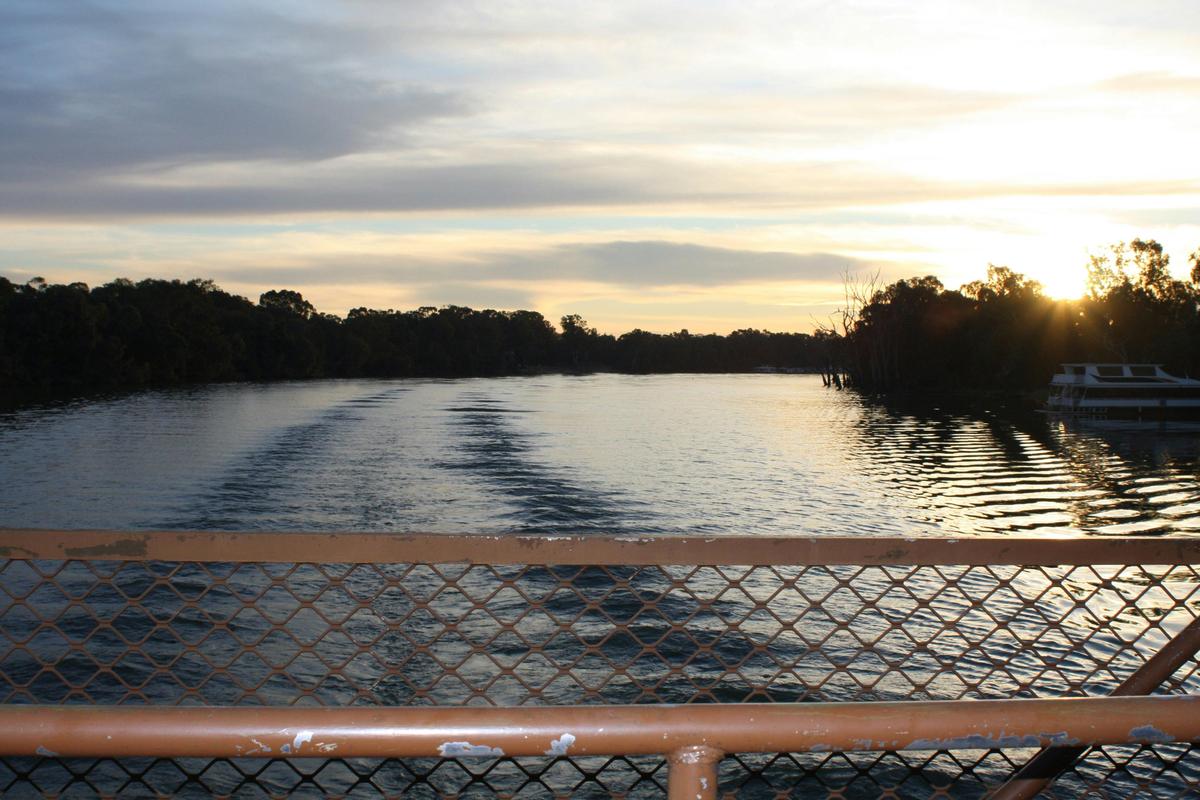 Looking out the back deck of the PB Mundoo, as the sunsets on the horizon and the waves lap behind.