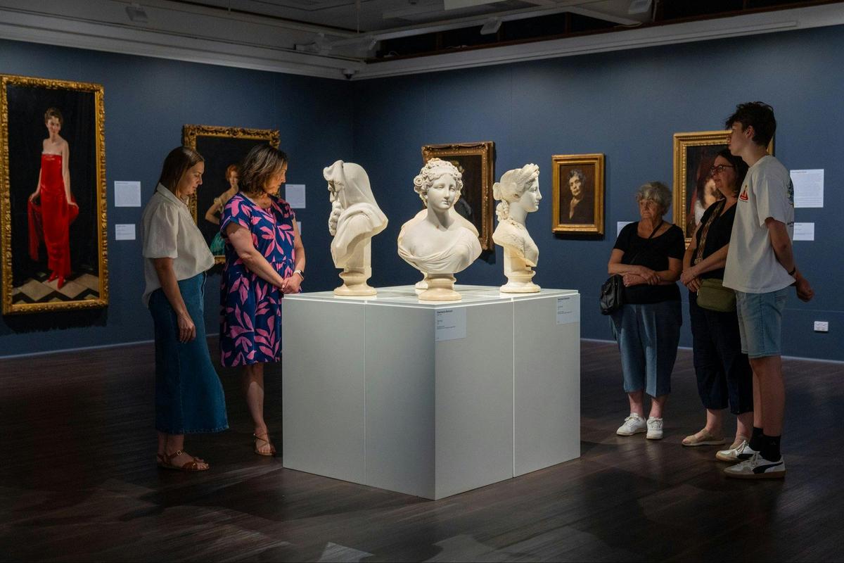 Five visitors in a gallery space