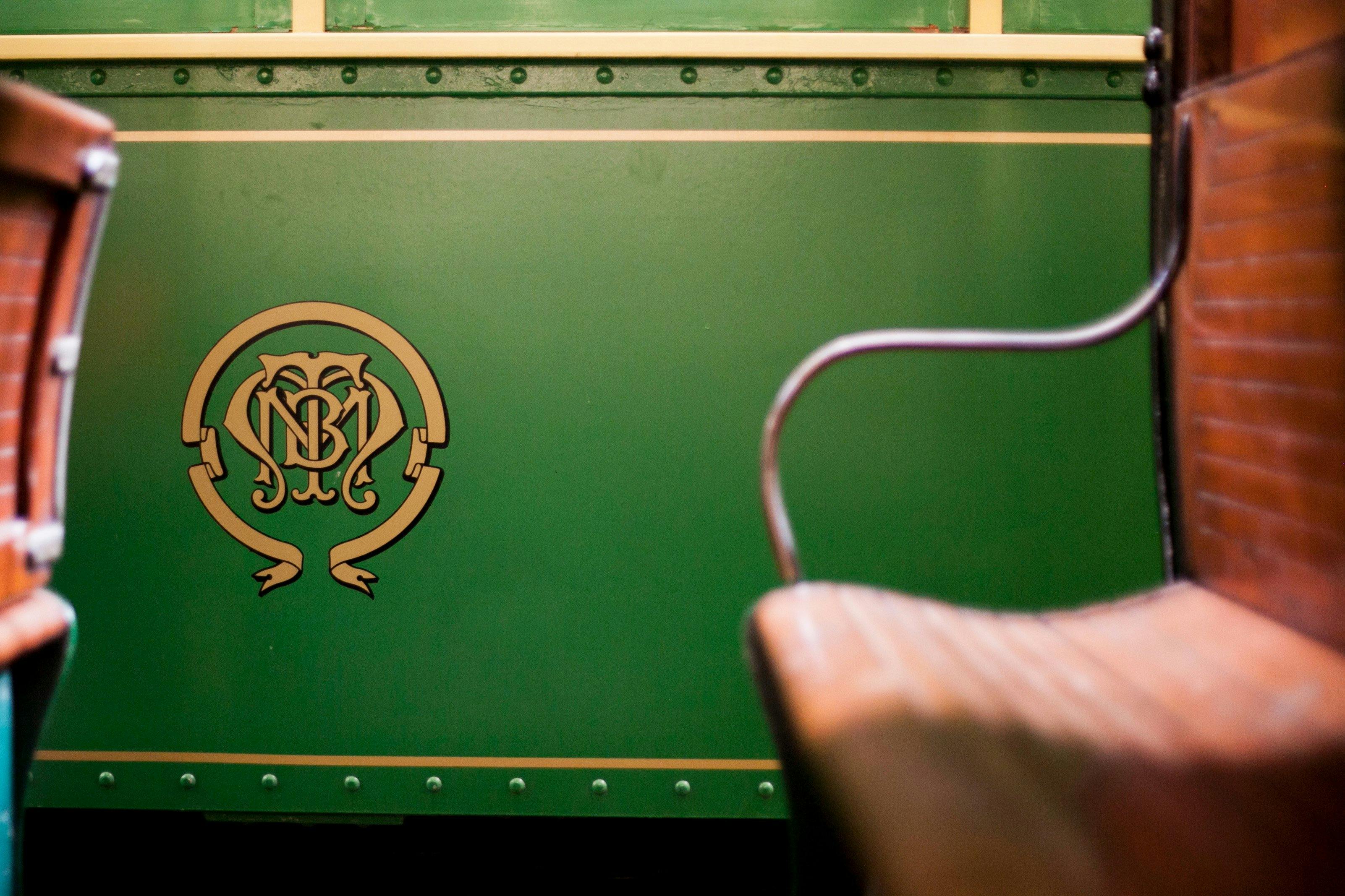 Side view of tramcar, featuring distinctive monogram crest of the Melbourne and Metropolitan Tramway
