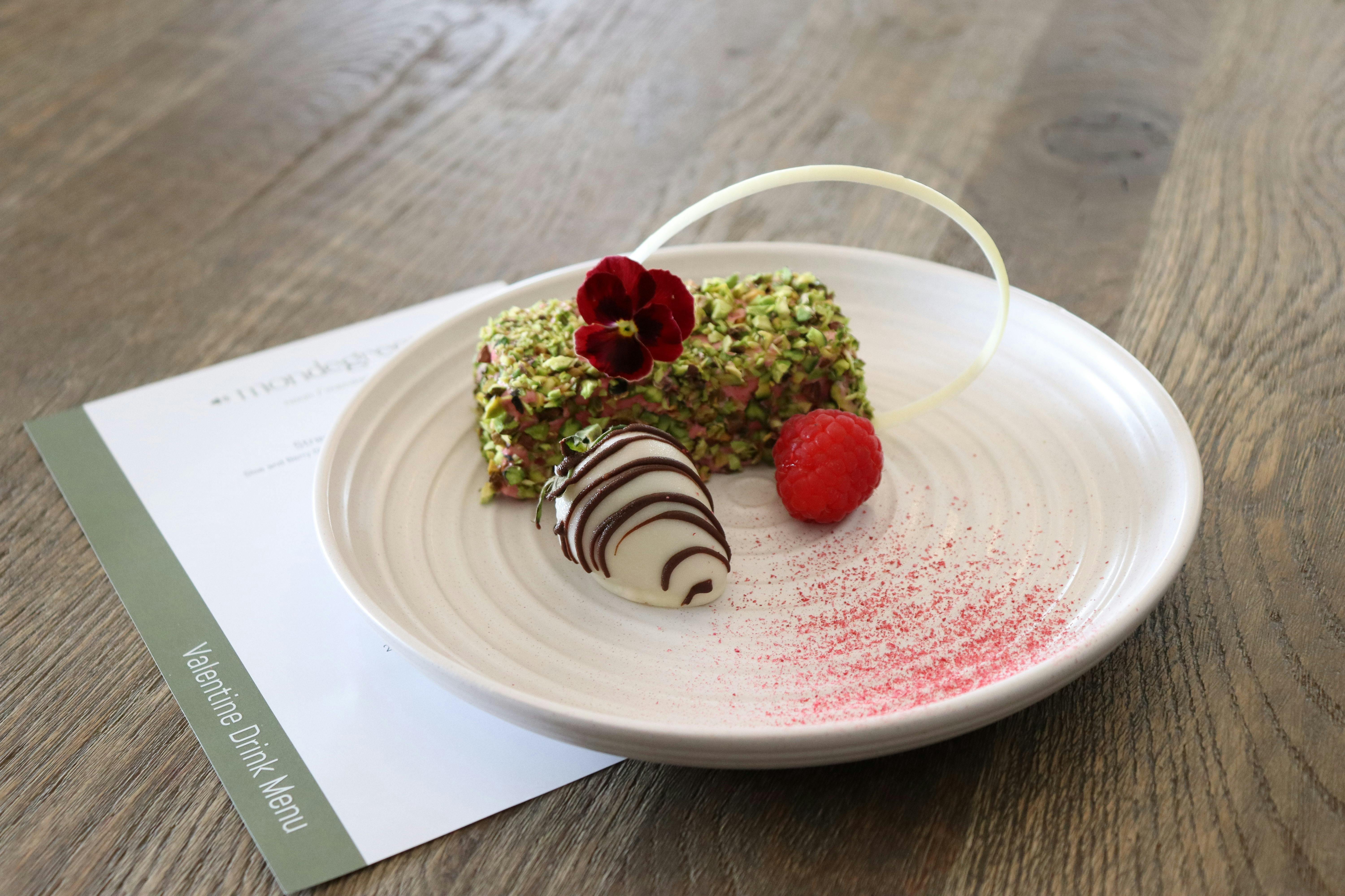 A plated dessert sitting on top of a Valentine's Dinner Menu