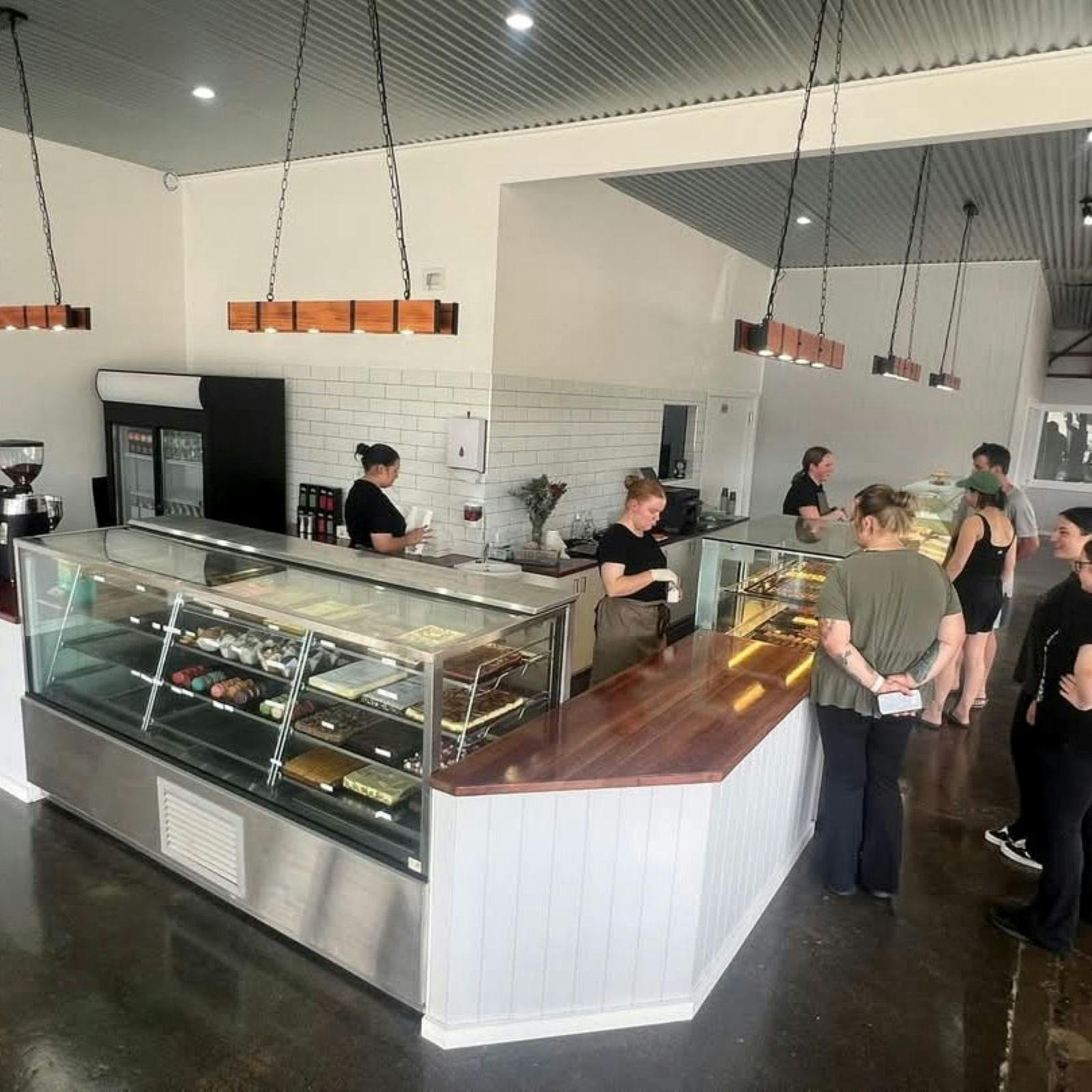 Image of a service counter with customers waiting as staff serve them