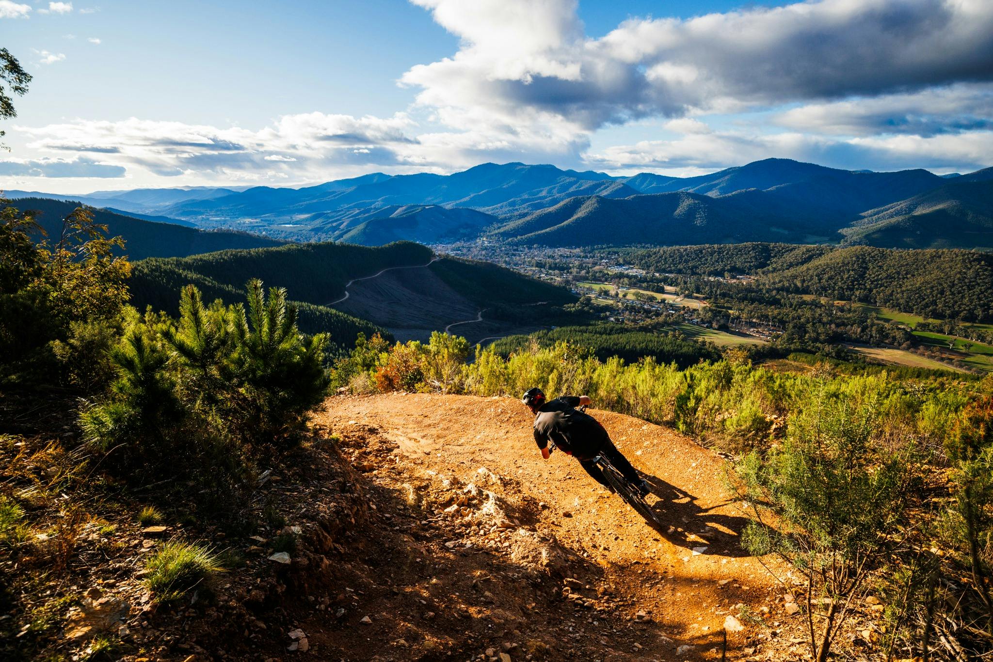 Riding at Mystic Bike Park with views of mountains