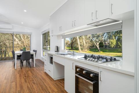 Premium family cabin showing dining and living area, as well as full kitchen