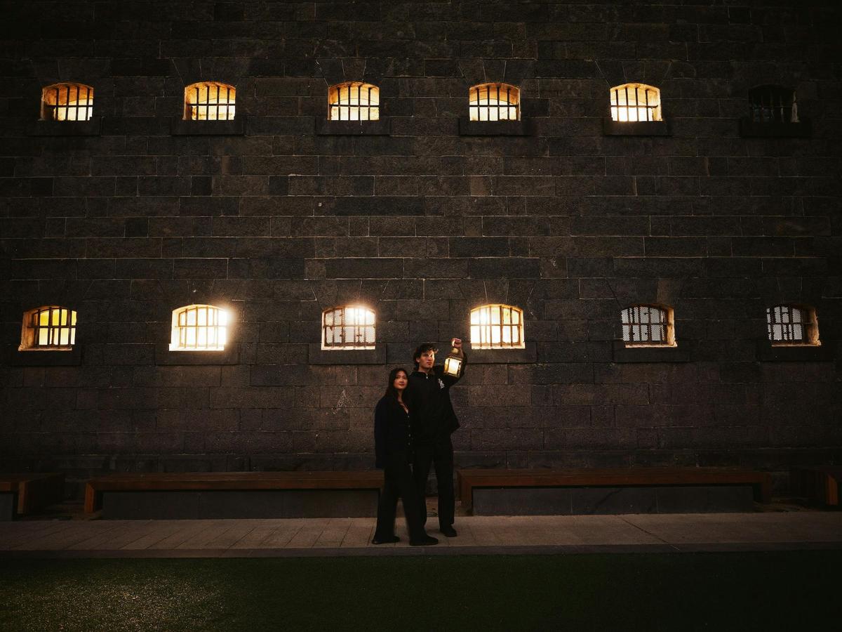 Couple outside of gaol at night