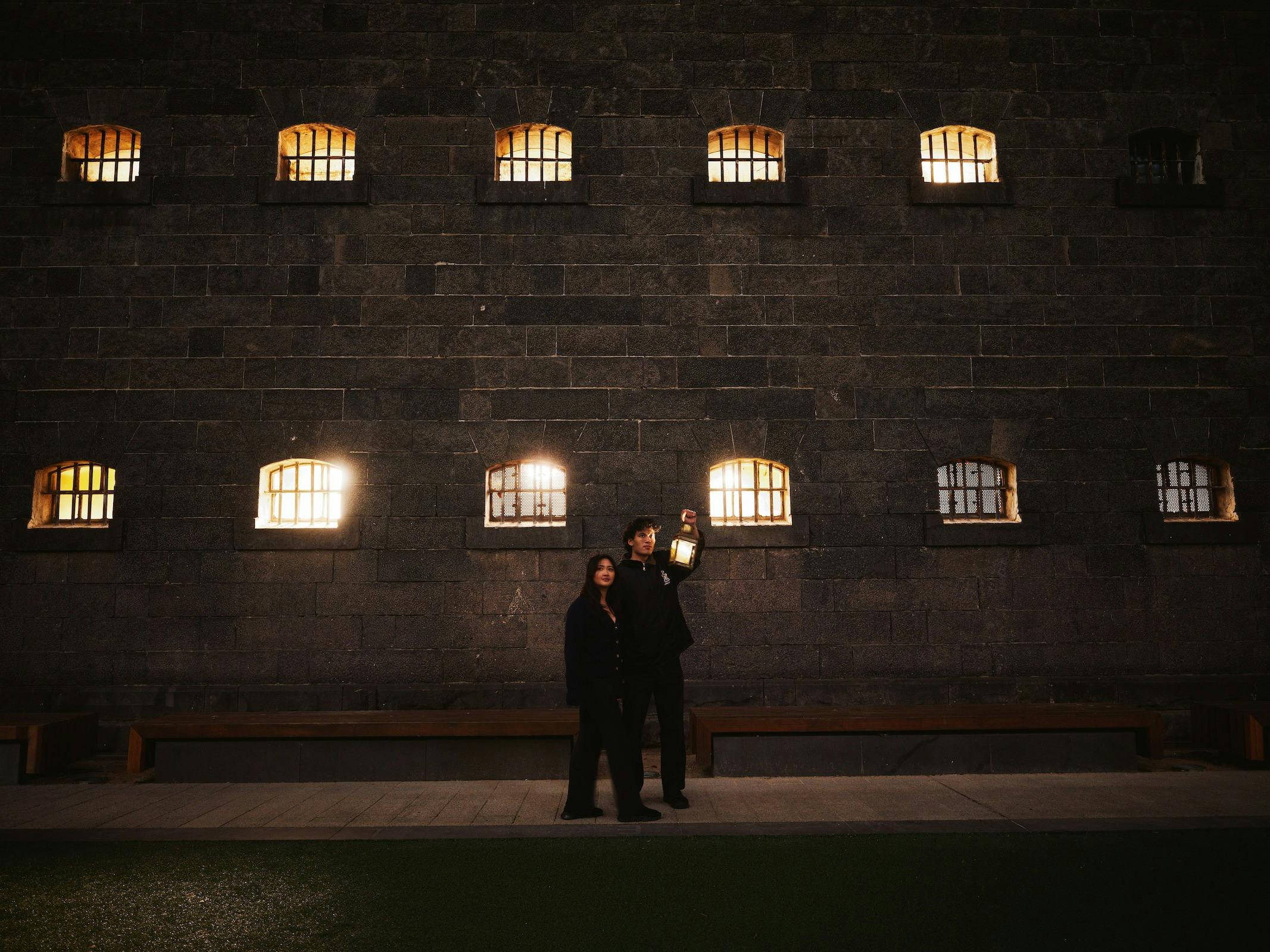 Couple outside of gaol at night