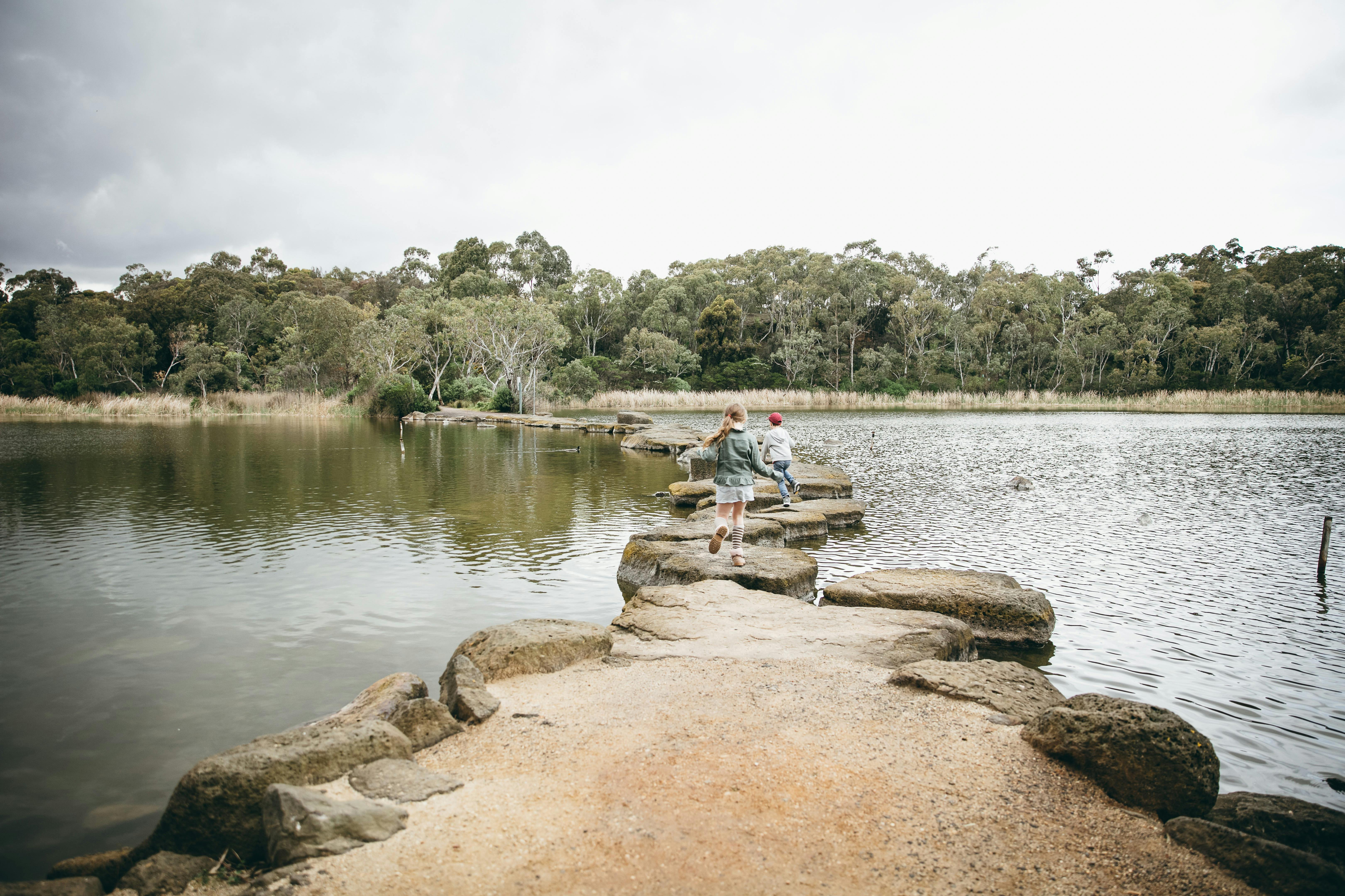Children on stepping stones at Newport Lakes