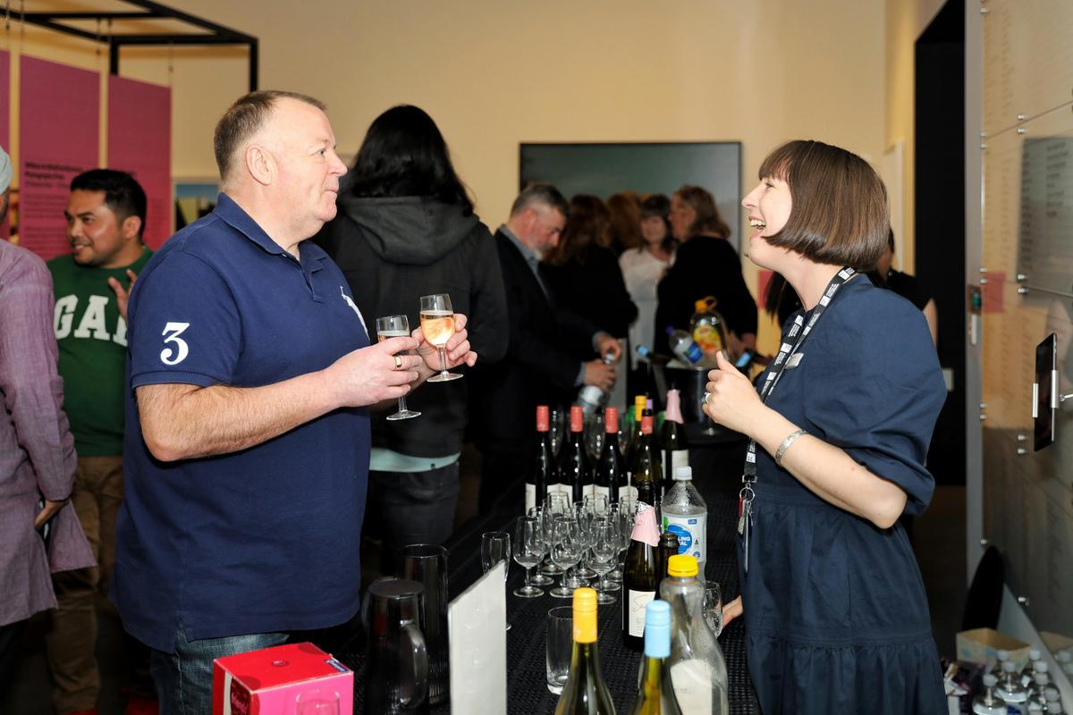 MAPh staff serve guests at an exhibition launch