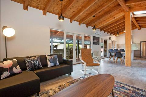 Spacious living, dining and kitchen area, timber-lined ceiling