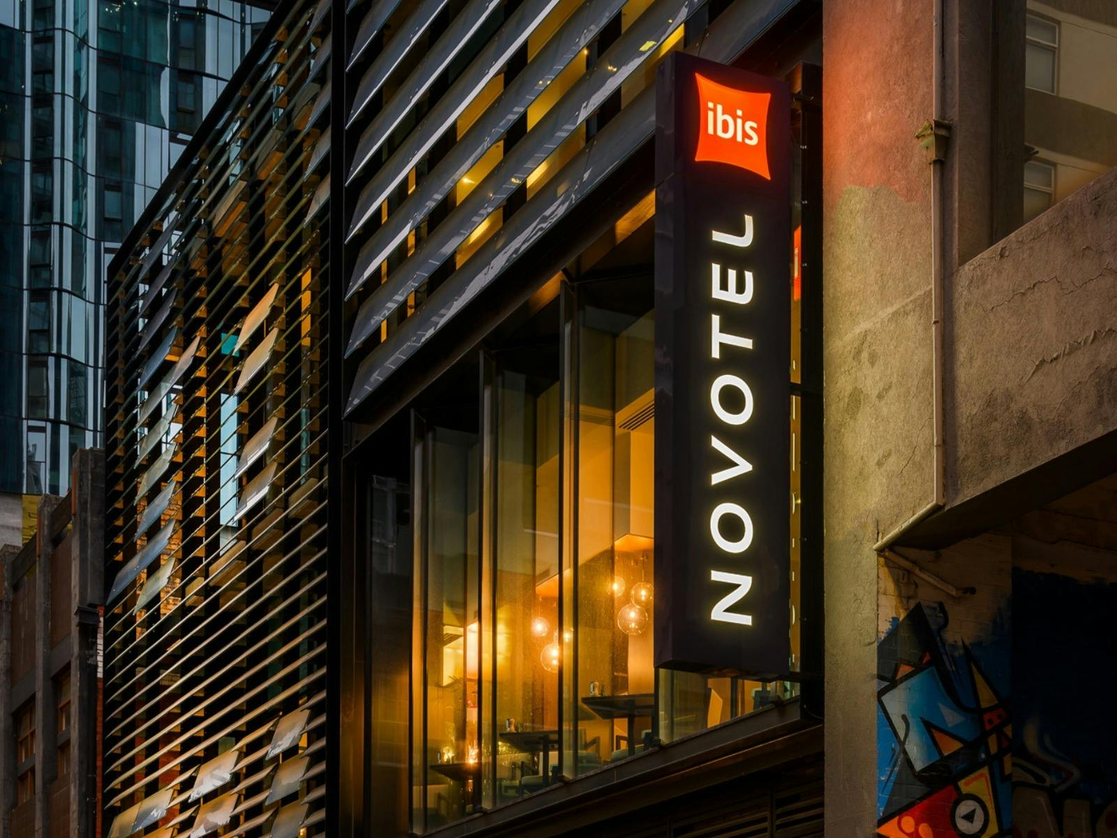 Modern façade featuring Novotel & ibis signage