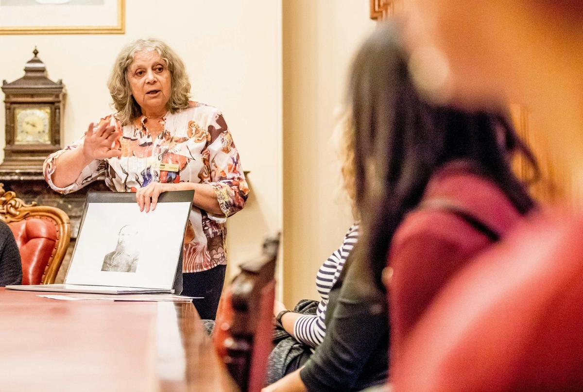 Colour photograph of a woman presenting to a crowd.