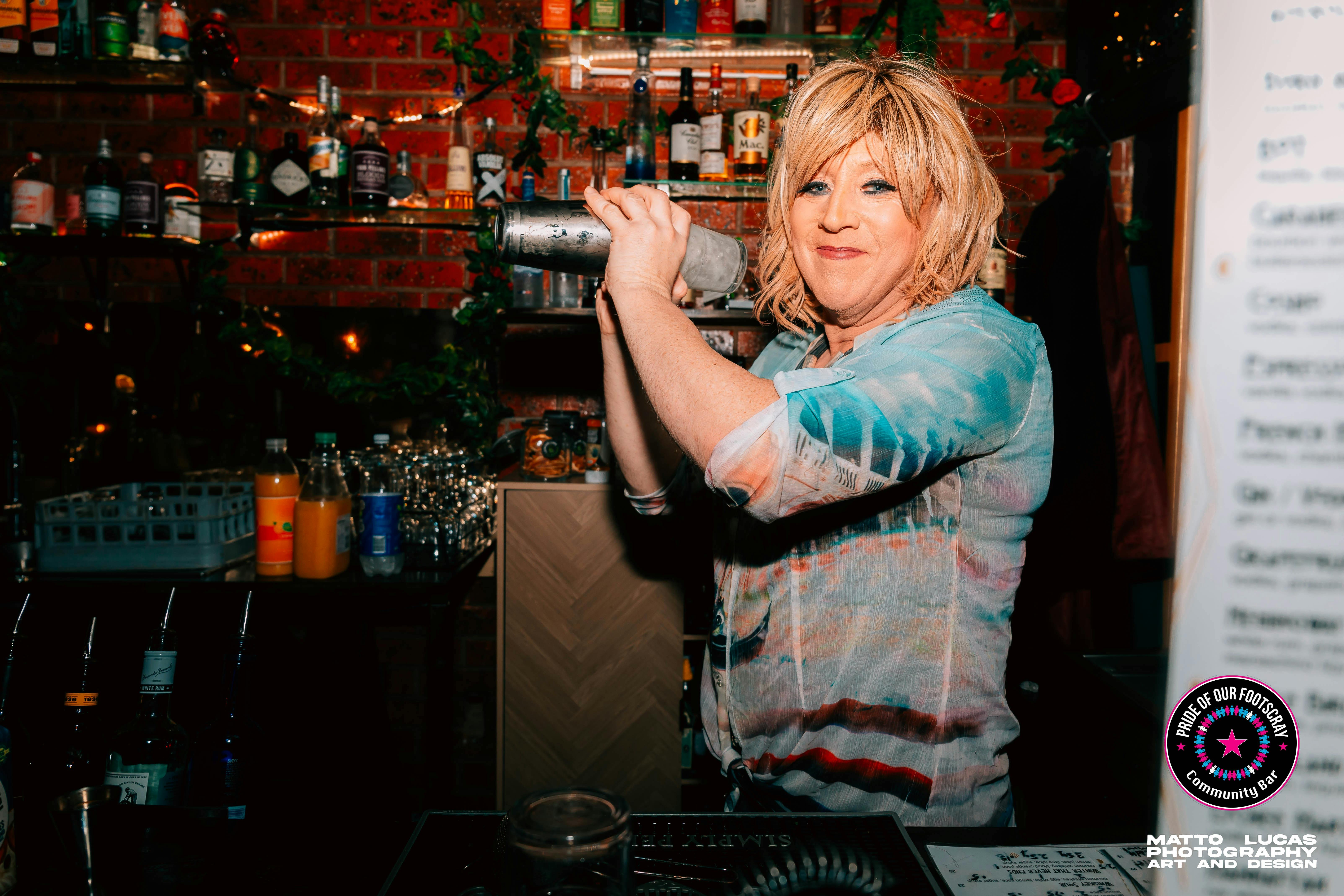 One of Pride's beautiful staff members shakes a cocktail