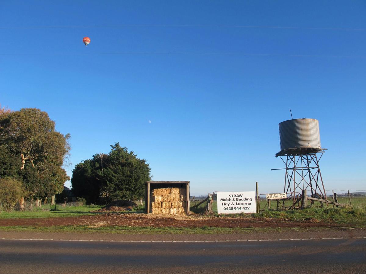 Hot air balloon through farm equipment at Daylesford