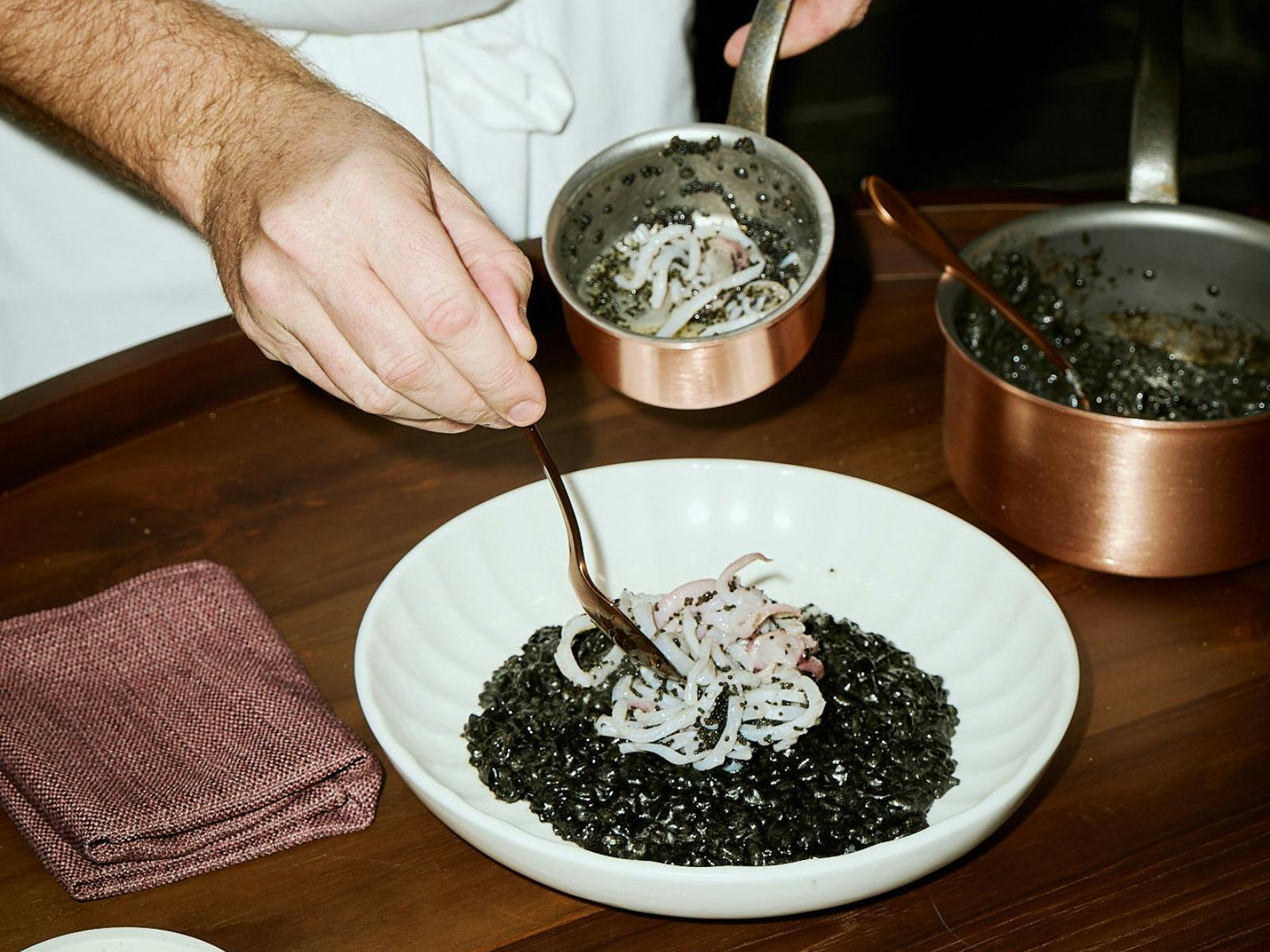 Chef plating a dish at Pascale Bar & Grill