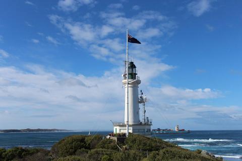 Point Lonsdale Lighthouse overlooking the ocean and a ship