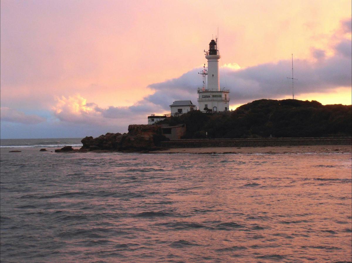 Point Lonsdale Lighthouse at sunset on the rocks with ocean
