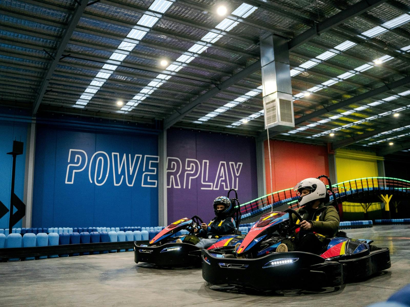 Man and woman racing a go kart at PowerPlay