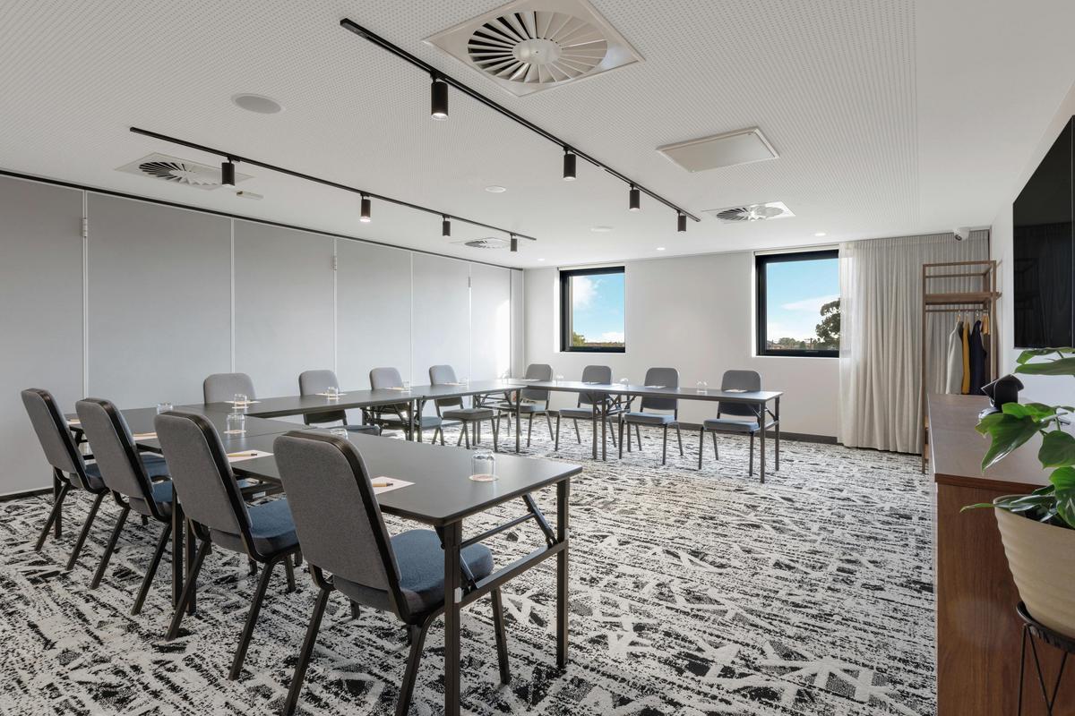 conference room with a U set up facing a screen