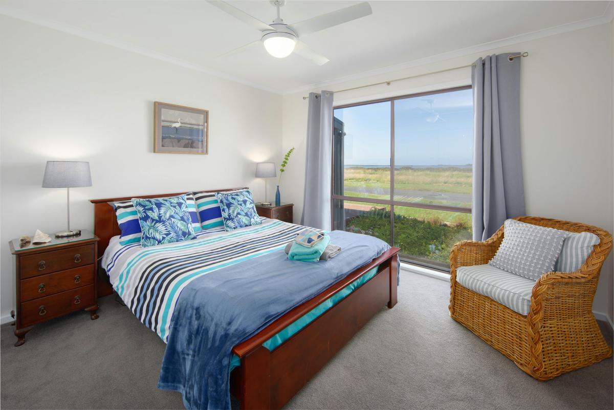 The Bluewater Room has bedside tables, built in wardrobe, chair, full length mirror and water views