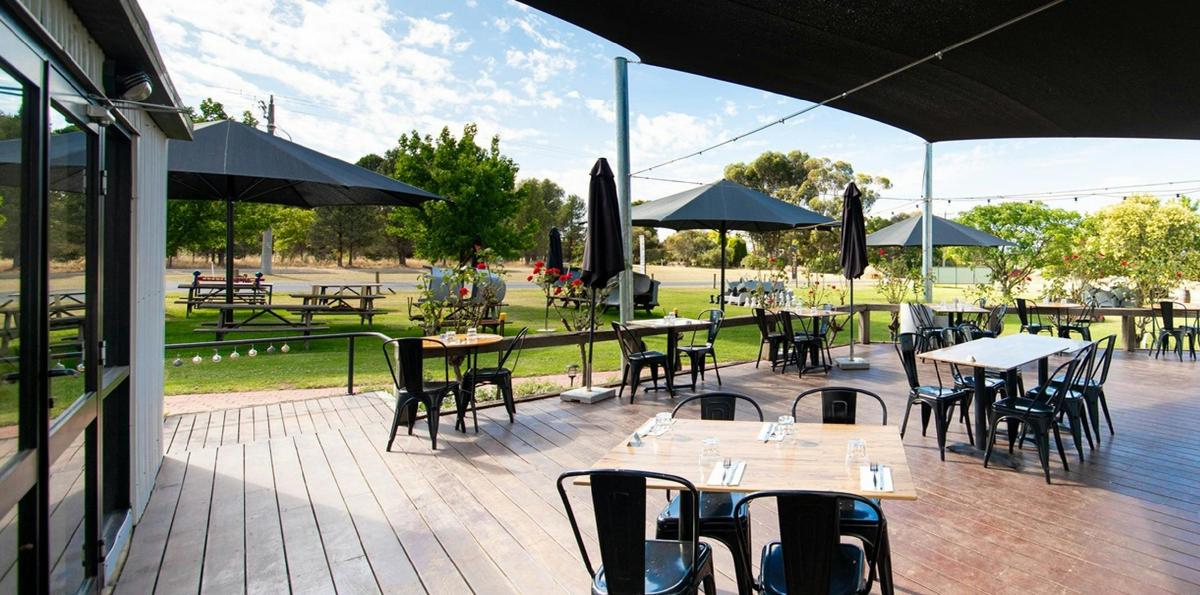 Relax on the shaded outdoor terrace at Quartz Cuisine, overlooking the gardens at Cofield Wines.
