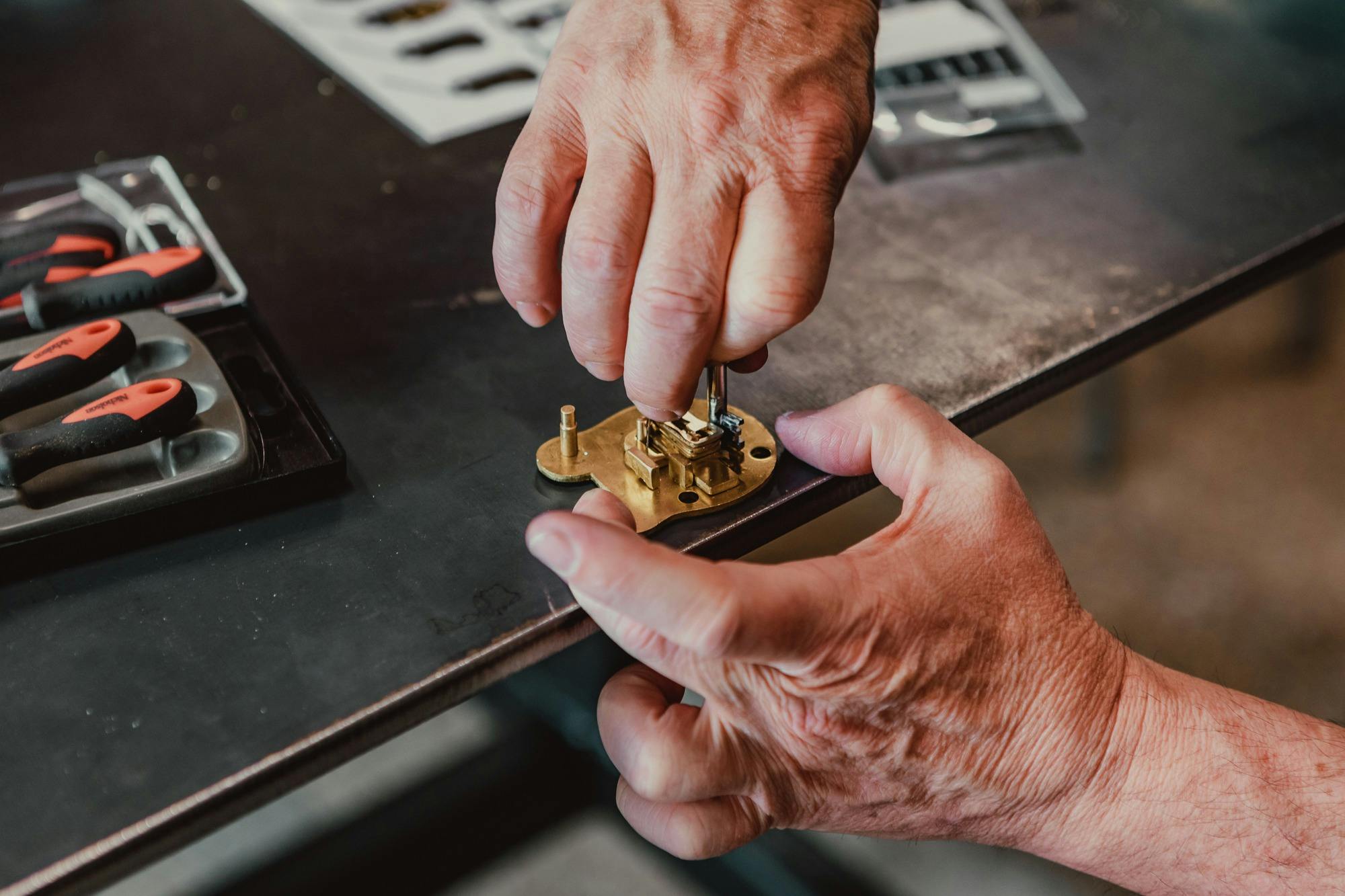 Close up. of hands making a lock on a work bench