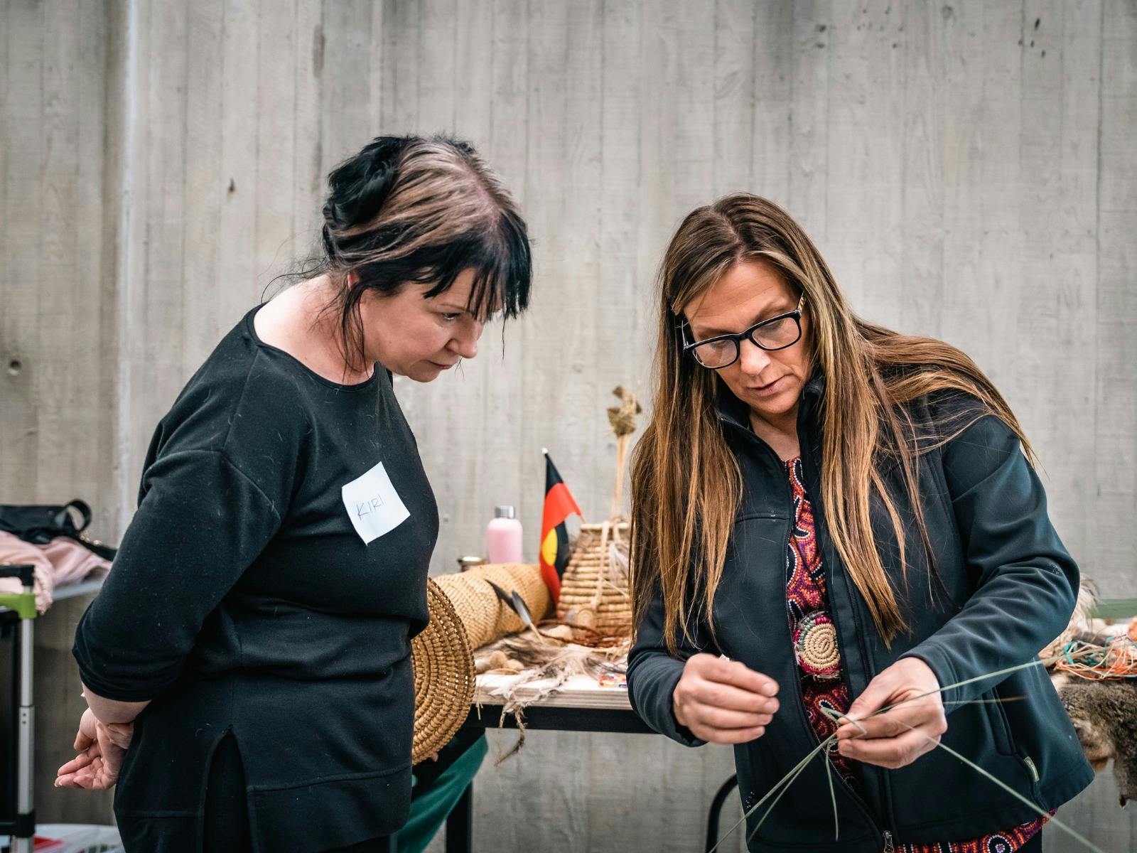 One woman showing another weaving