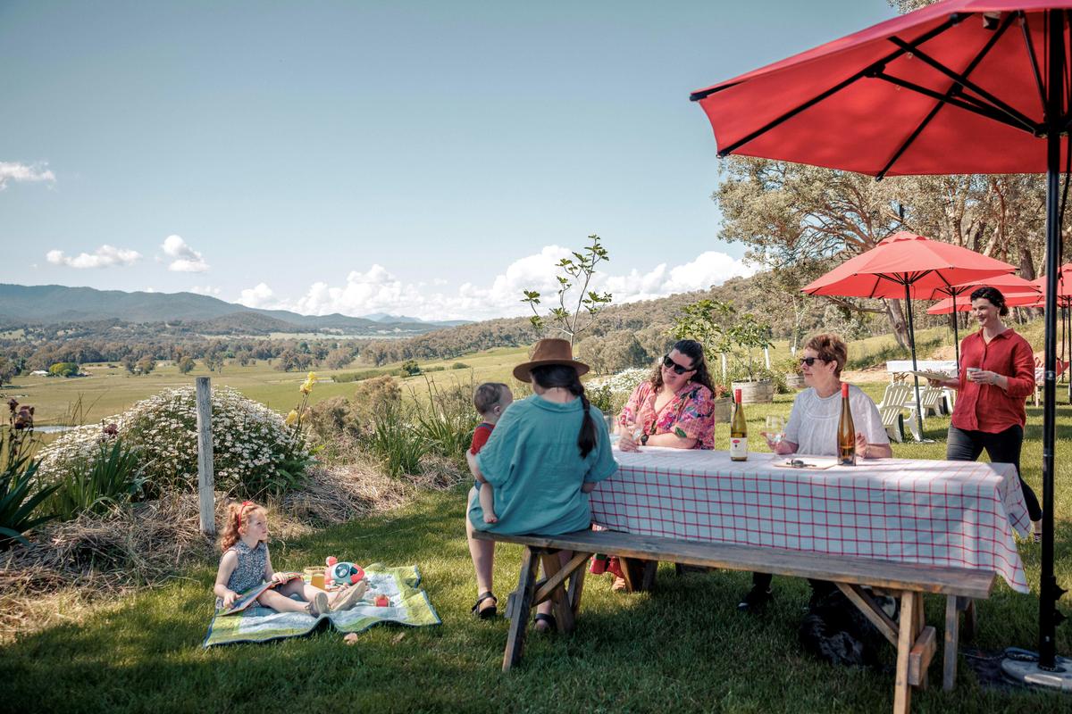 Three ladies enjoying a glass of wine with Kids overlooking the King Valley