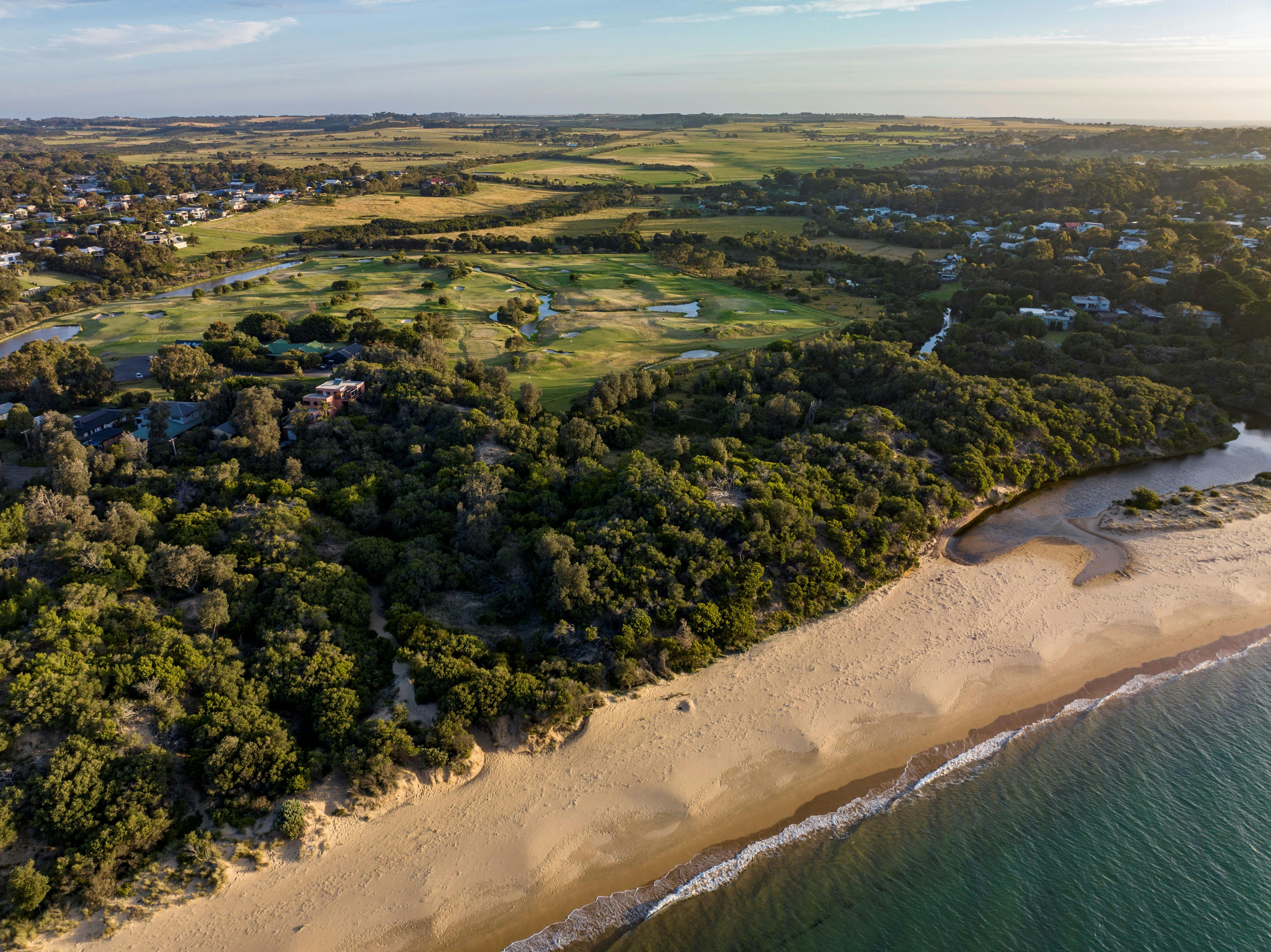 Drone shot looking south over Red Rocks Beach to the property