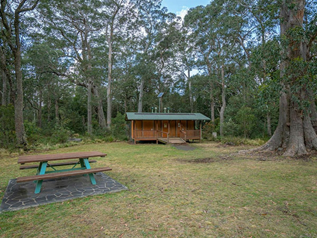 A picnic table and toilet facilities at Honeysuckle picnic area in Barrington Tops National Park.