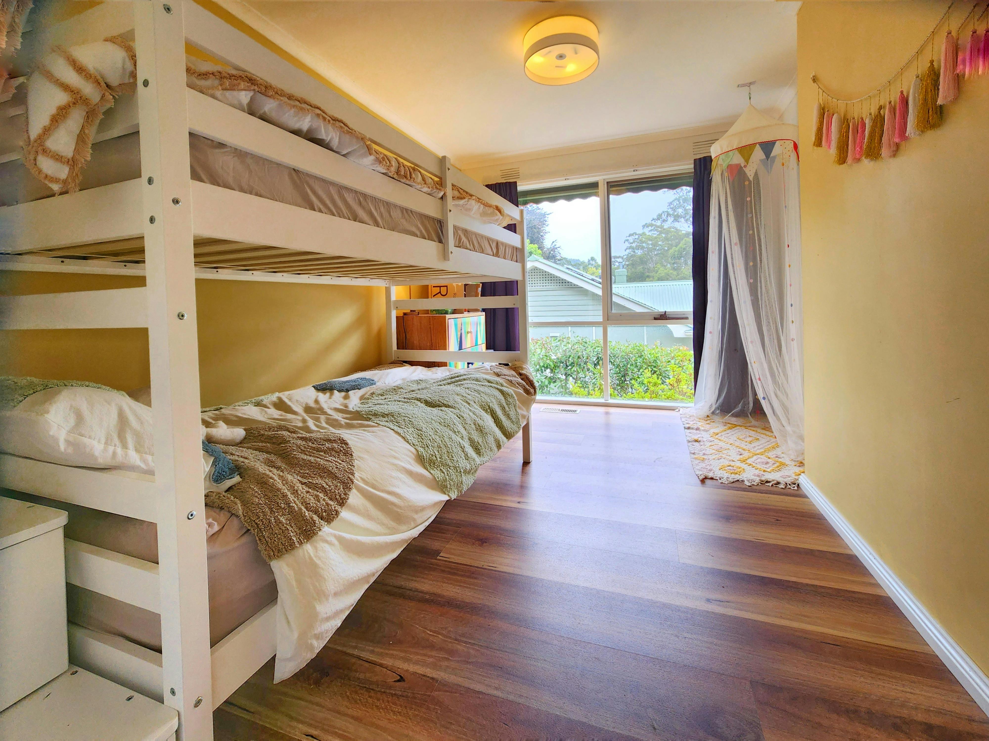 Kids room has double bunks, screen and blockout blinds, dresser