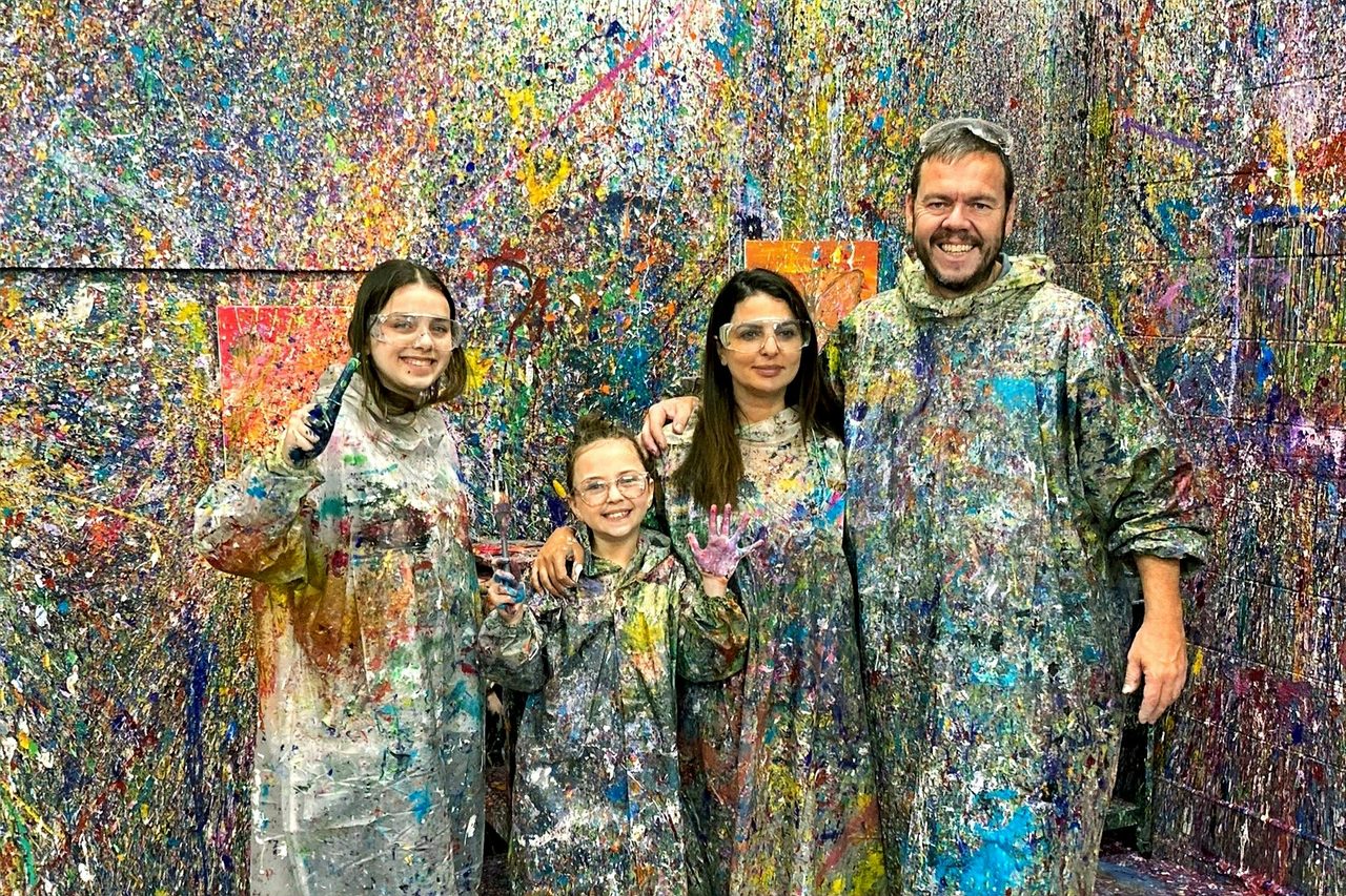 Family in front of colourful splatter paint wall, Kaboo Studio