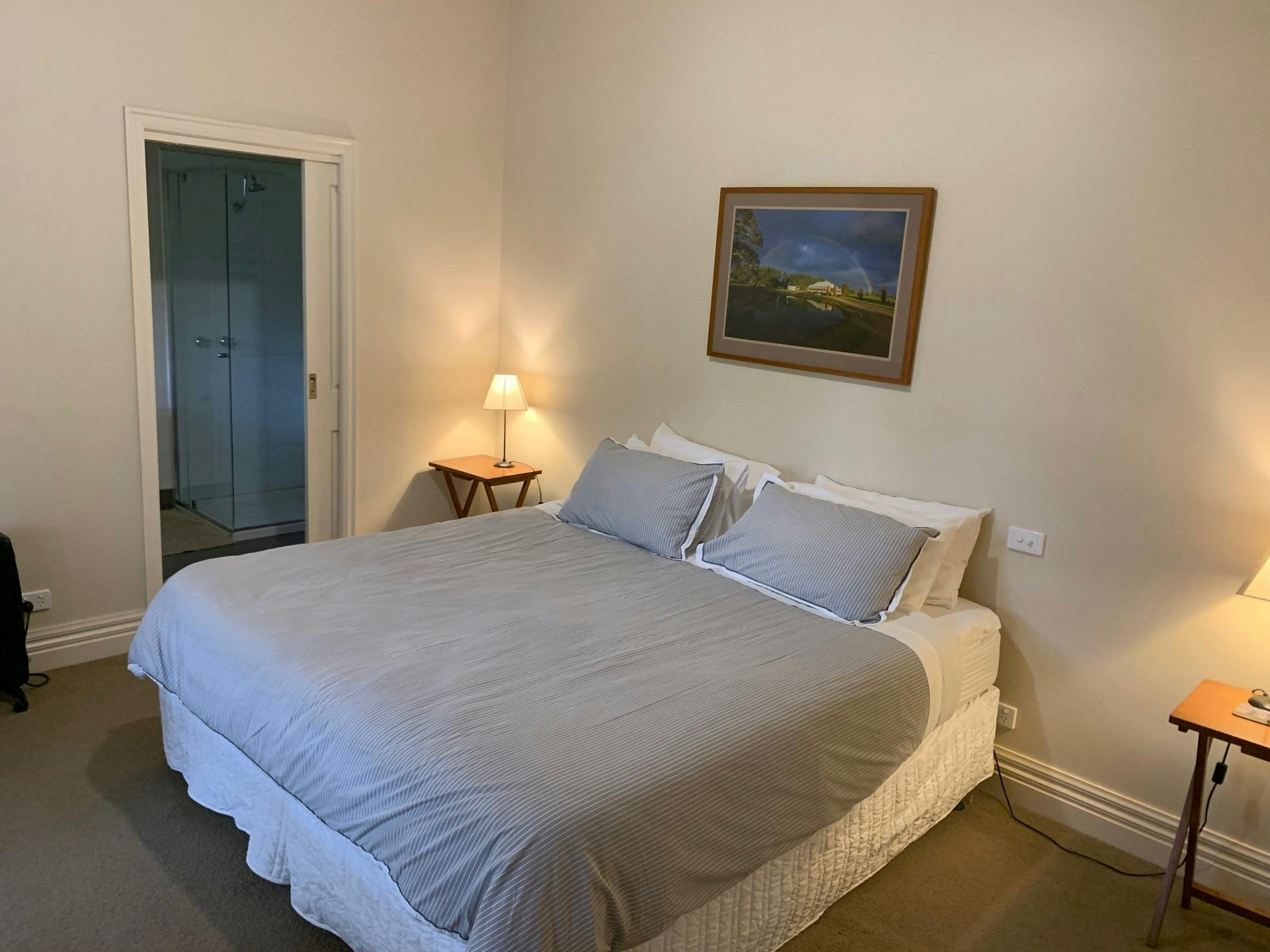 Bedroom with bed and bed side tables and lamps at Rosedale House Mansfield