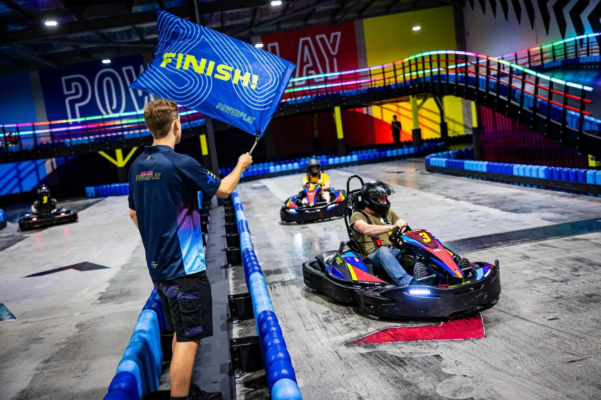 Man crossing the finish line in a go kart