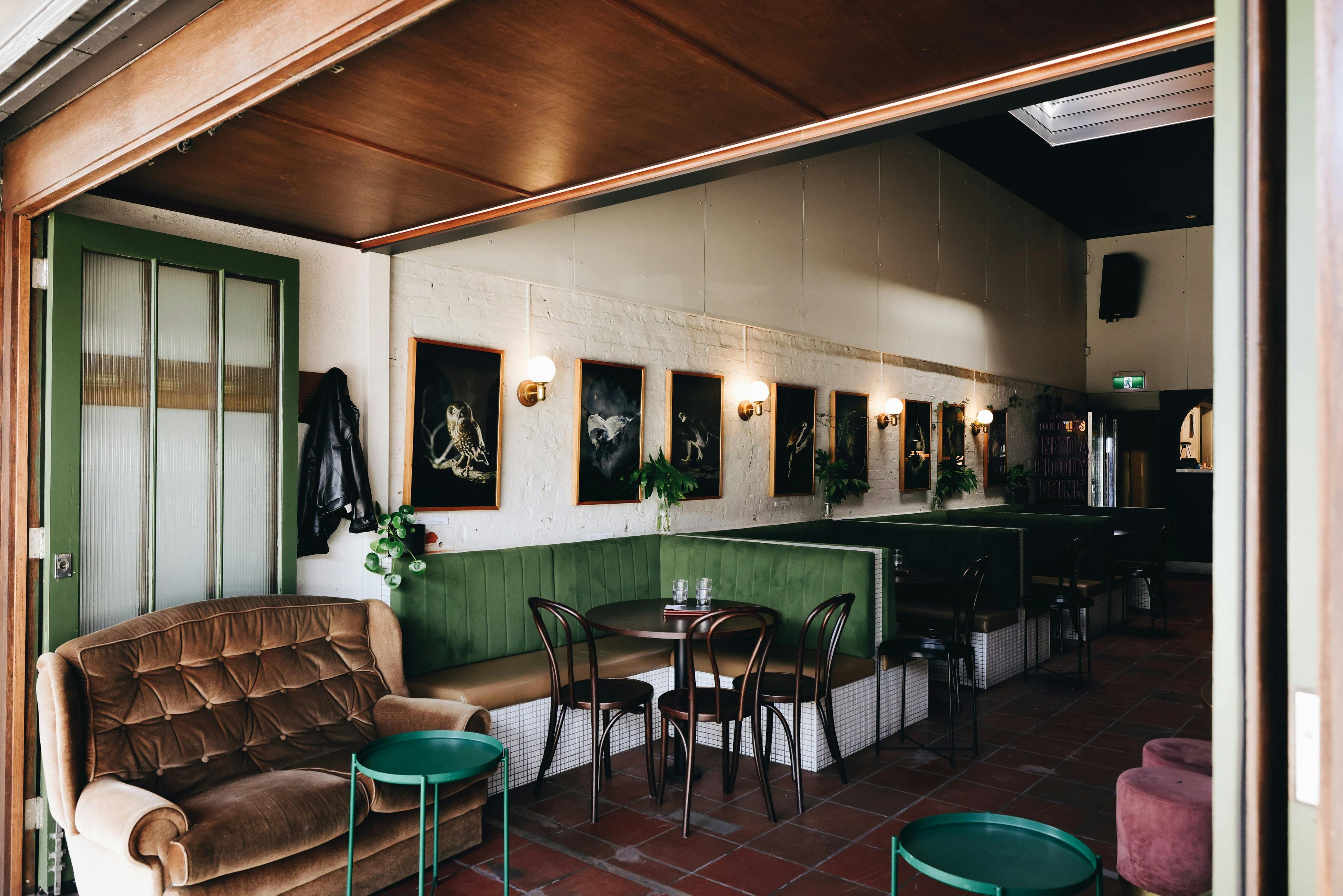 Couches and booth seating by open French Doors