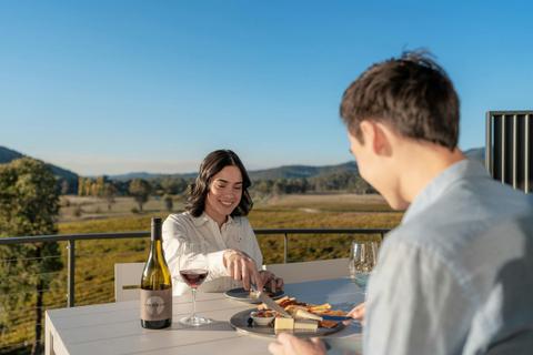 Couple enjoying wine and a cheese platter on the balcony at Retreat Studios Chrismont