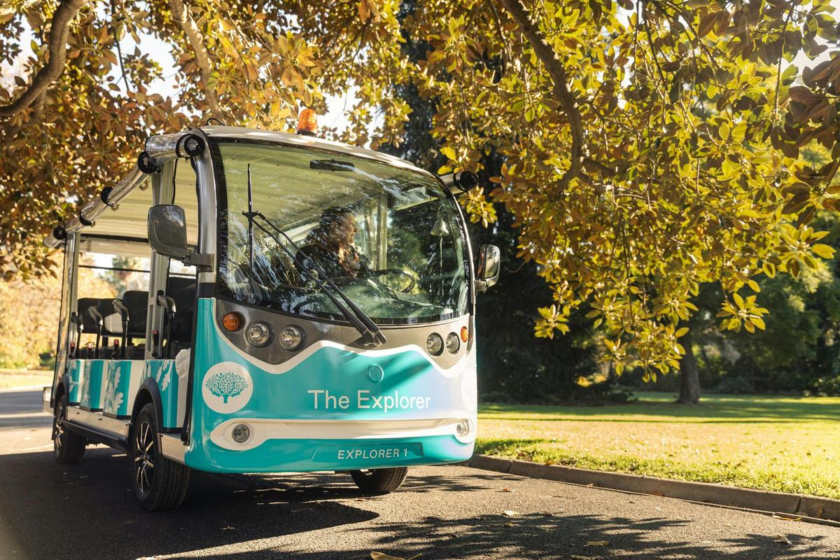 'Explorer' mini-bus looks out over a lawn while on a footpath.