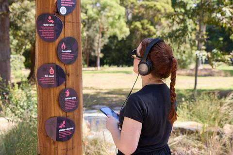 Woman with headphones looking at a sign