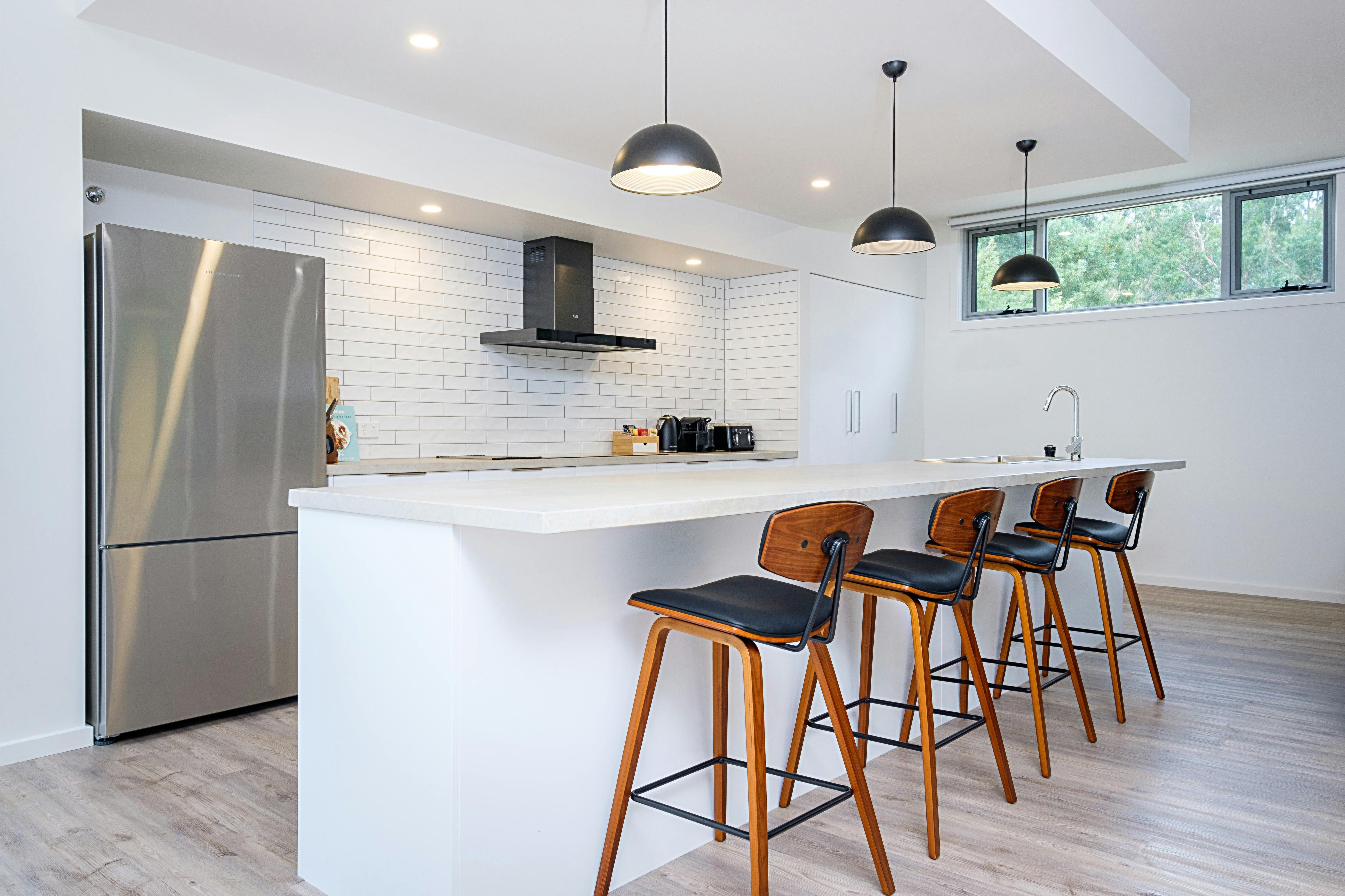 Modern kitchen with quality appliances including selection of Teas & Nespresso coffee pods.