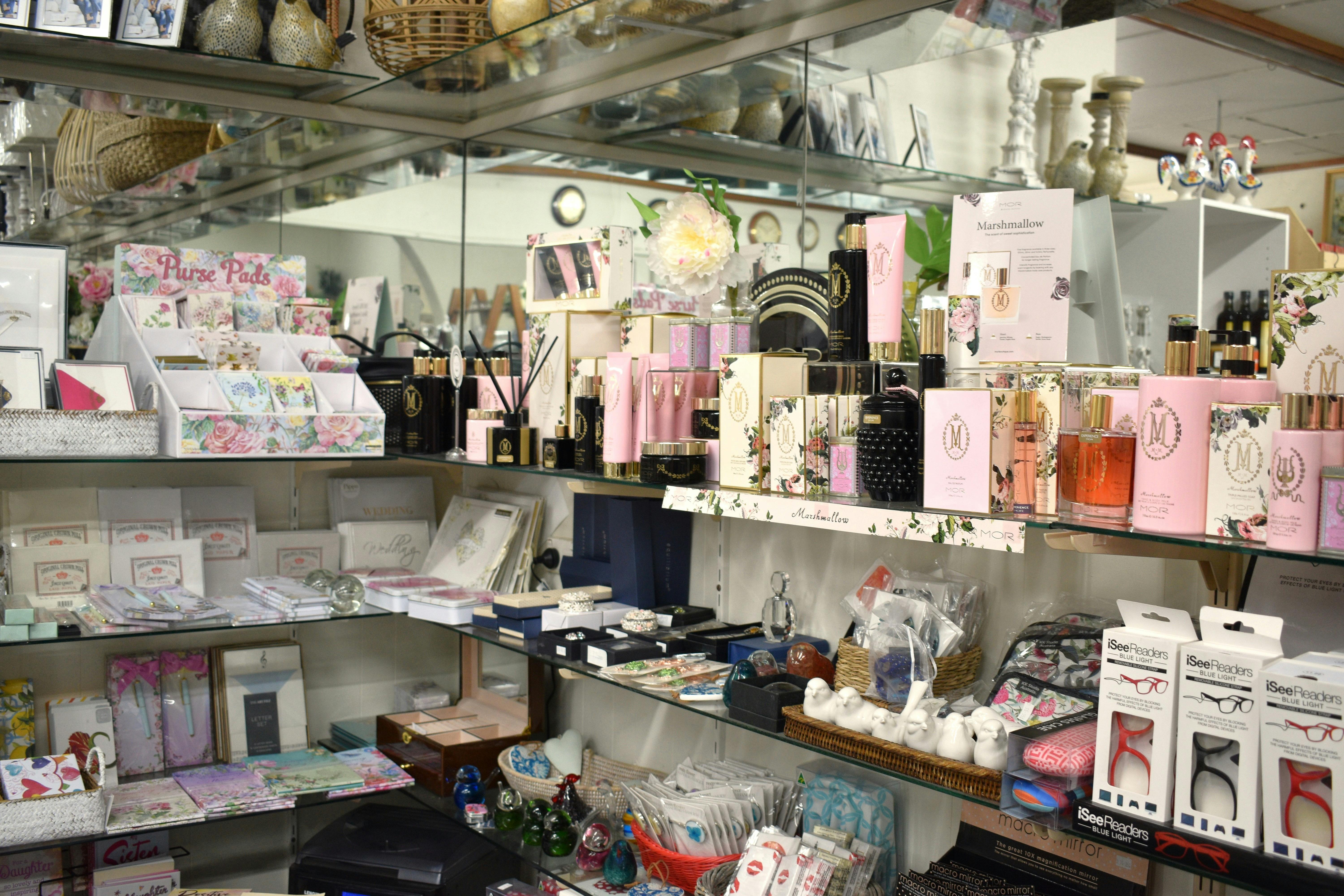 Corner shelves filled with an array of beauty products and stationary.