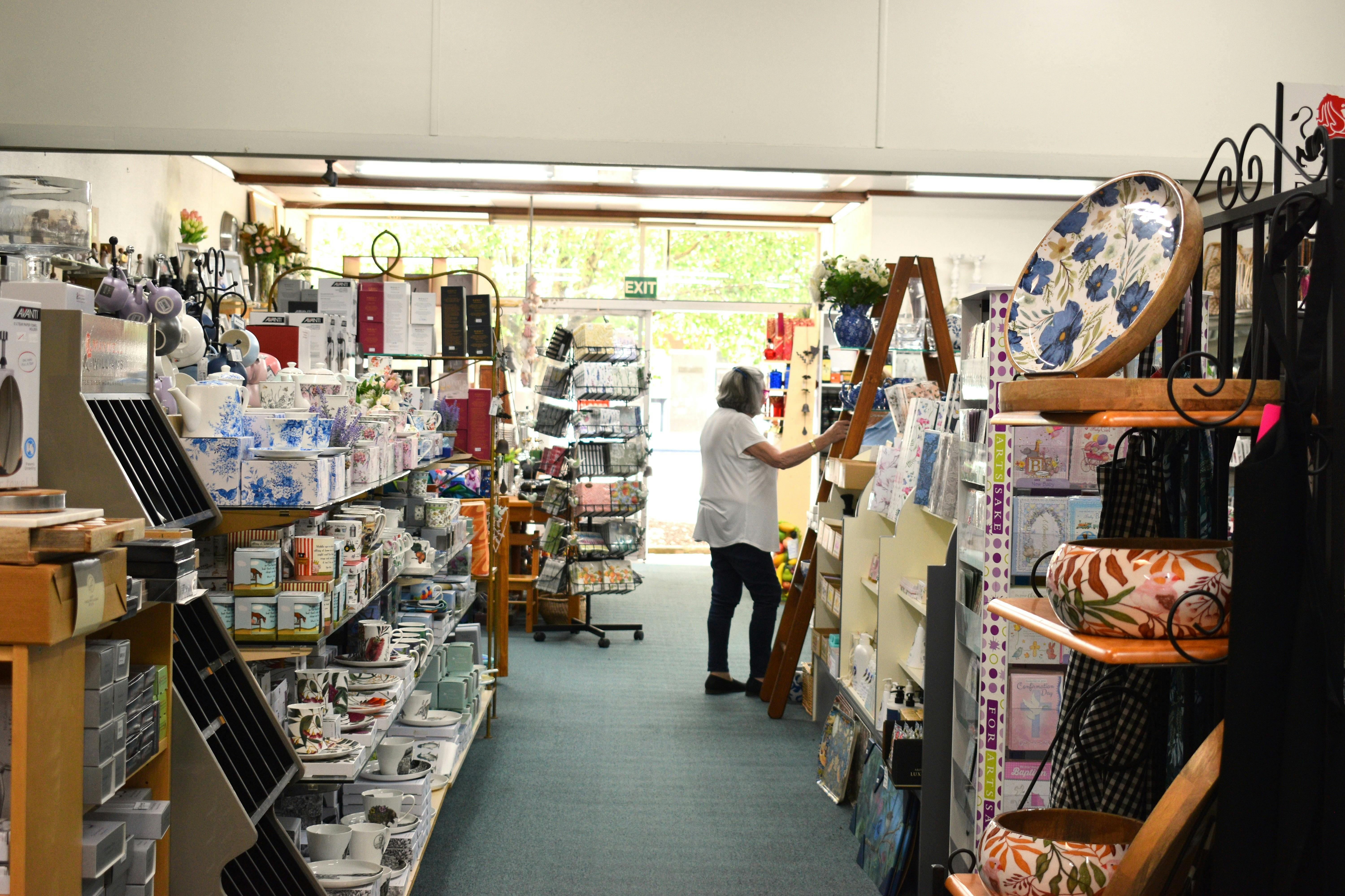 Inside store with a visitor perusing items.