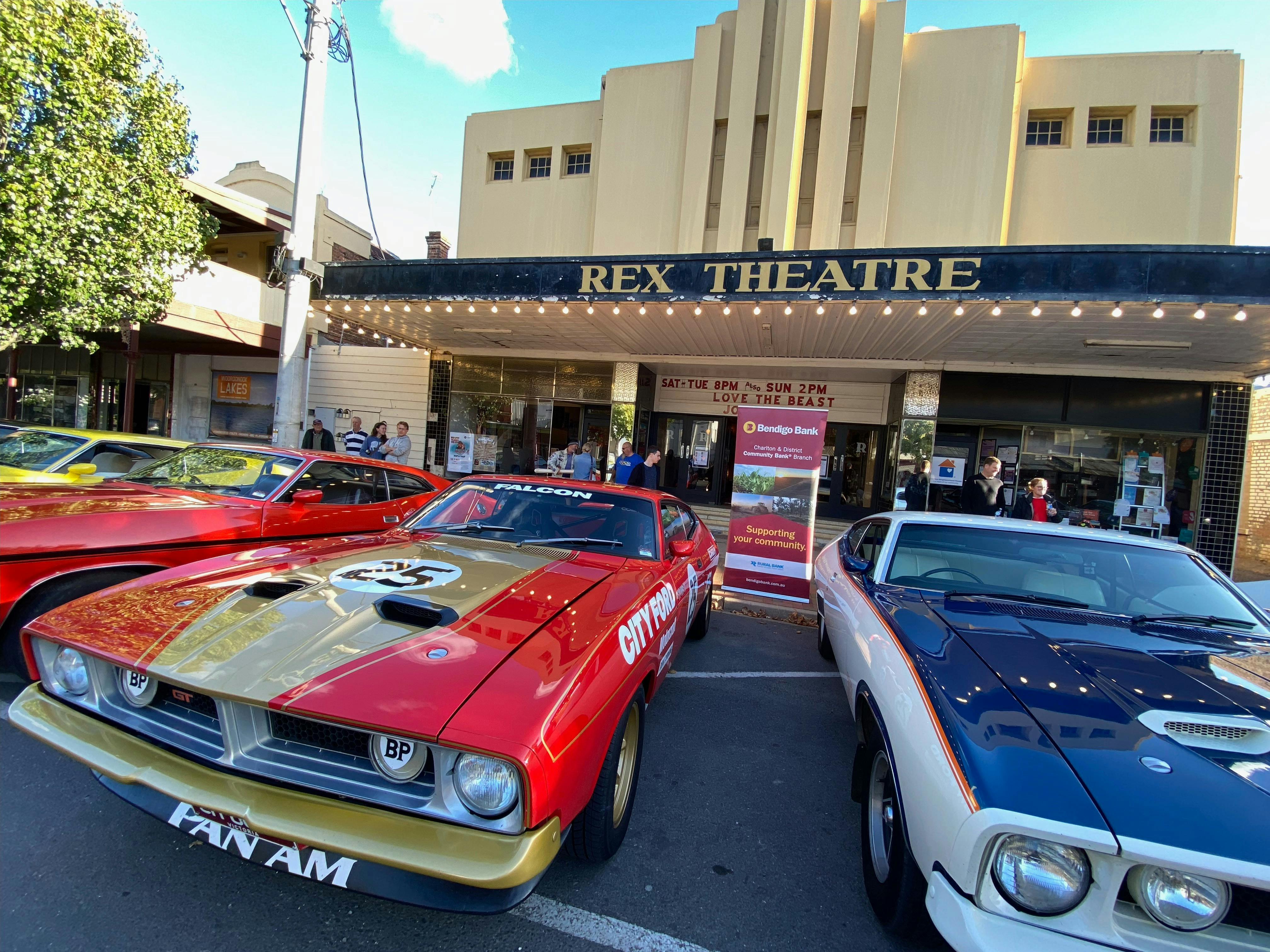 Stunning Ford coupes pictured in front of the Art Deco facade of The Rex