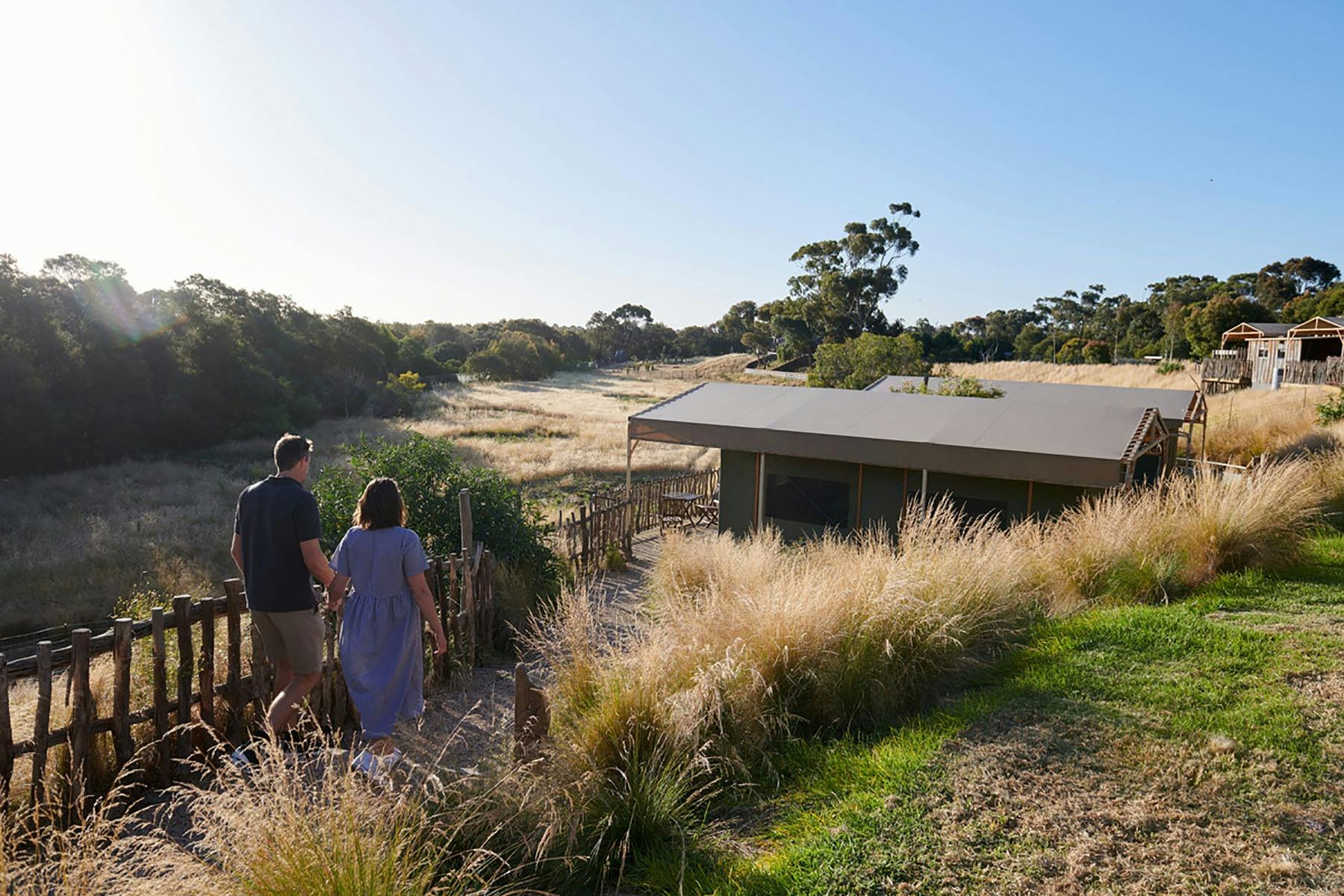 Two people walking towards cabins