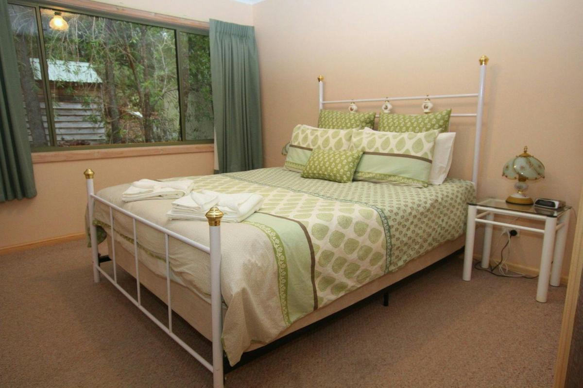 Large comfortable bed in a room with a side table