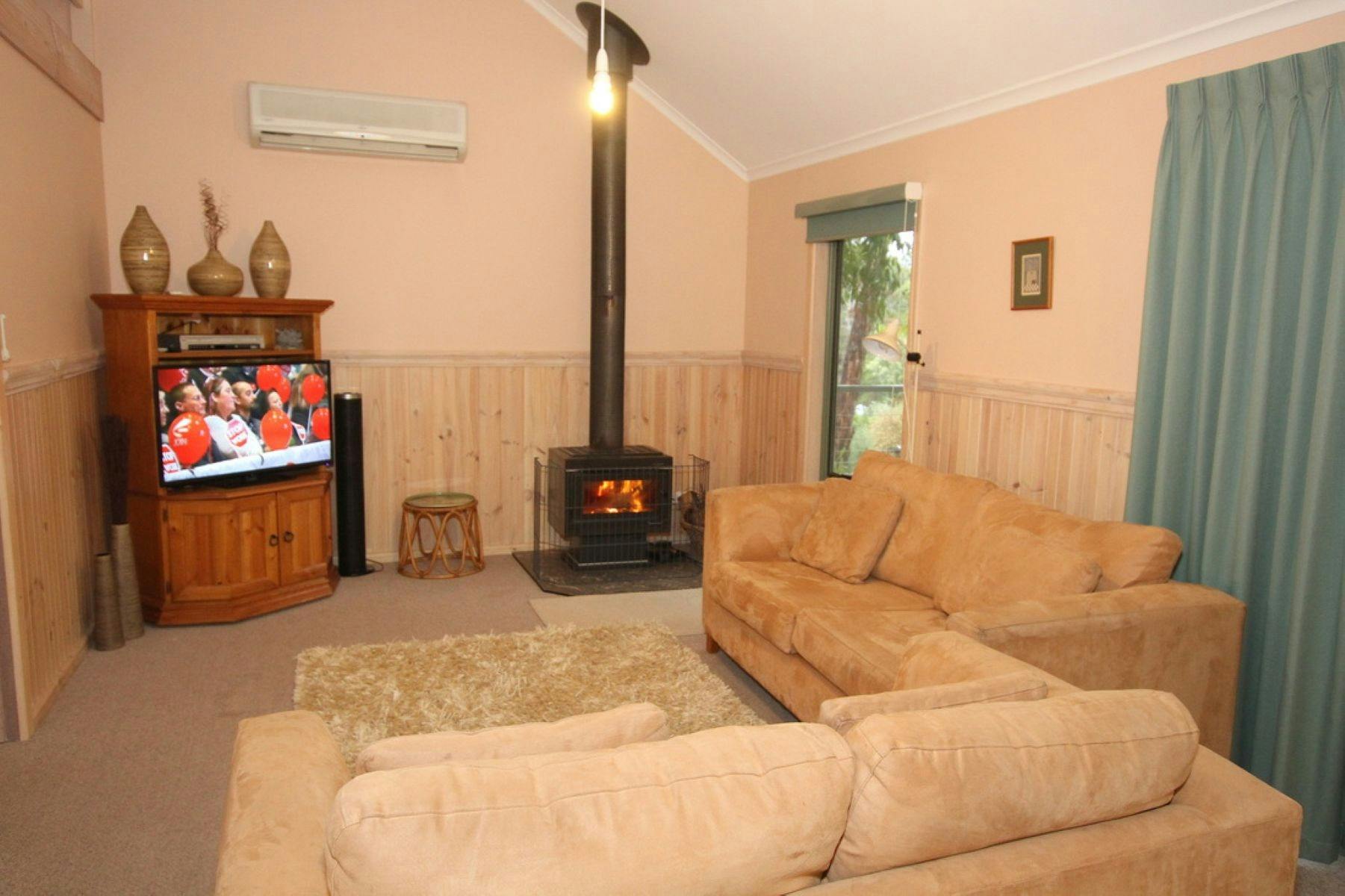 Lounge room with large suite and wood burning fire