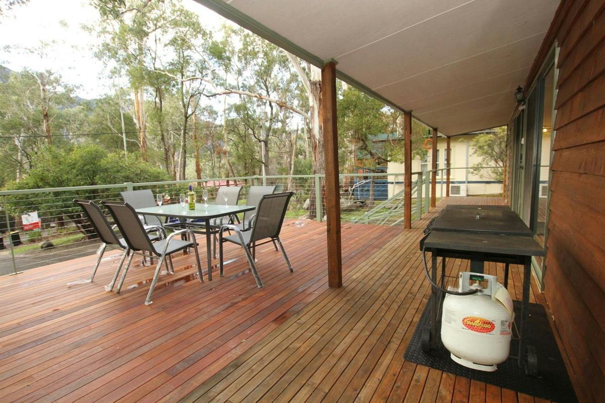 Front deck with outdoor setting and a barbecue