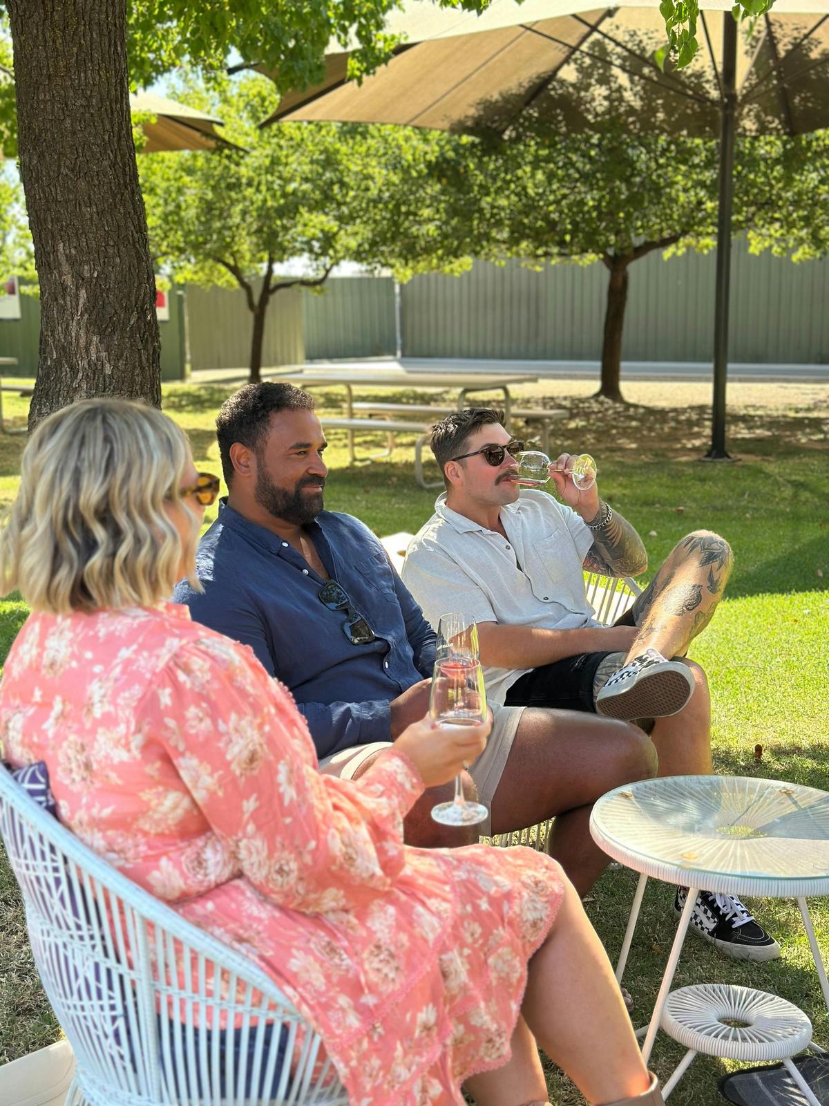 3 people sitting drinking wine
