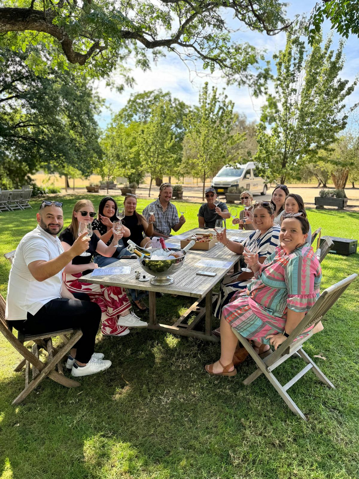 group of friends sitting at a wooden table